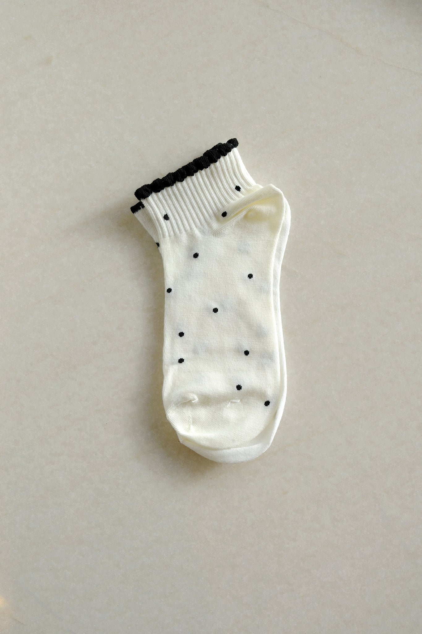 Chic white polka dot socks from Larrea Cove's new arrivals, blending playful patterns with a breezy coastal vibe.