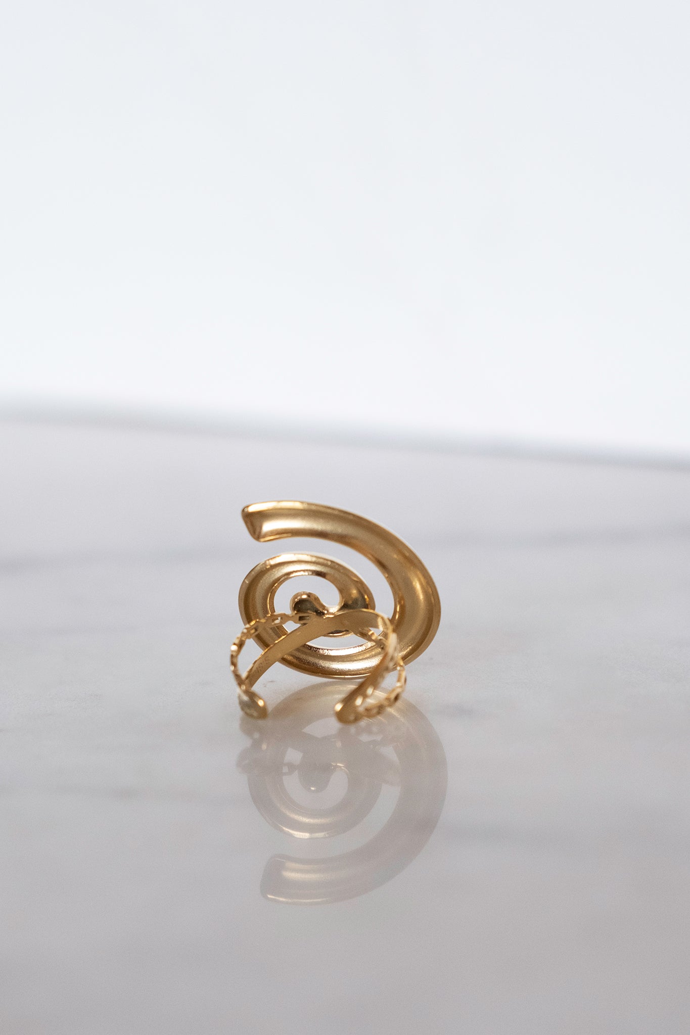 Golden swirl adjustable ring from Larrea Cove's new arrivals collection, capturing boho elegance with its intricate design