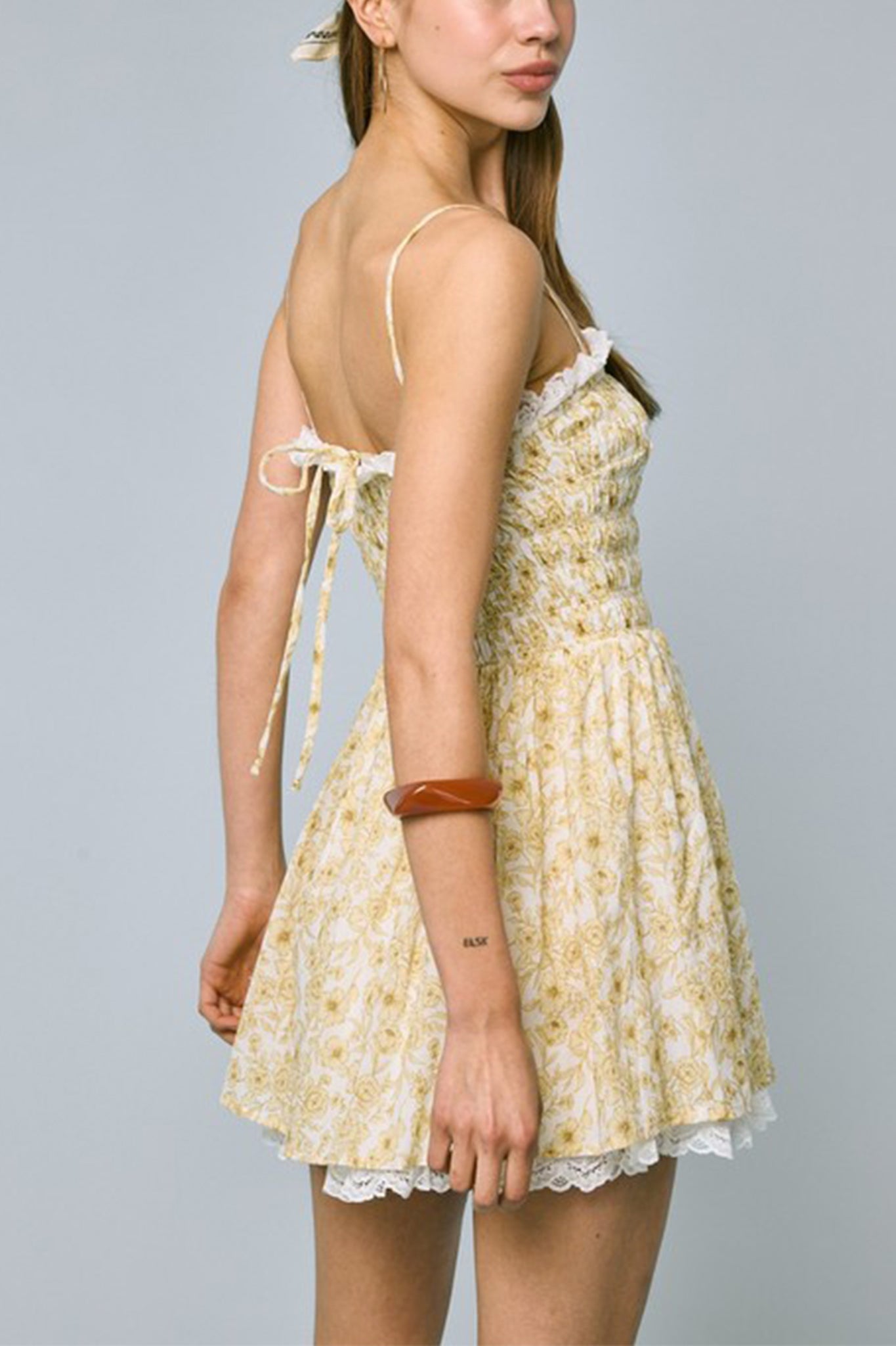Floral lace mini dress from Larrea Cove, blending boho charm with intricate detailing, perfect for sunlit coastal days.