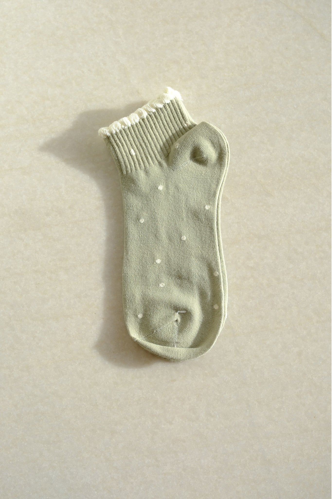 Sage polka dot socks, a fresh addition to new arrivals, blend playful charm with Larrea Cove's bohemian spirit.