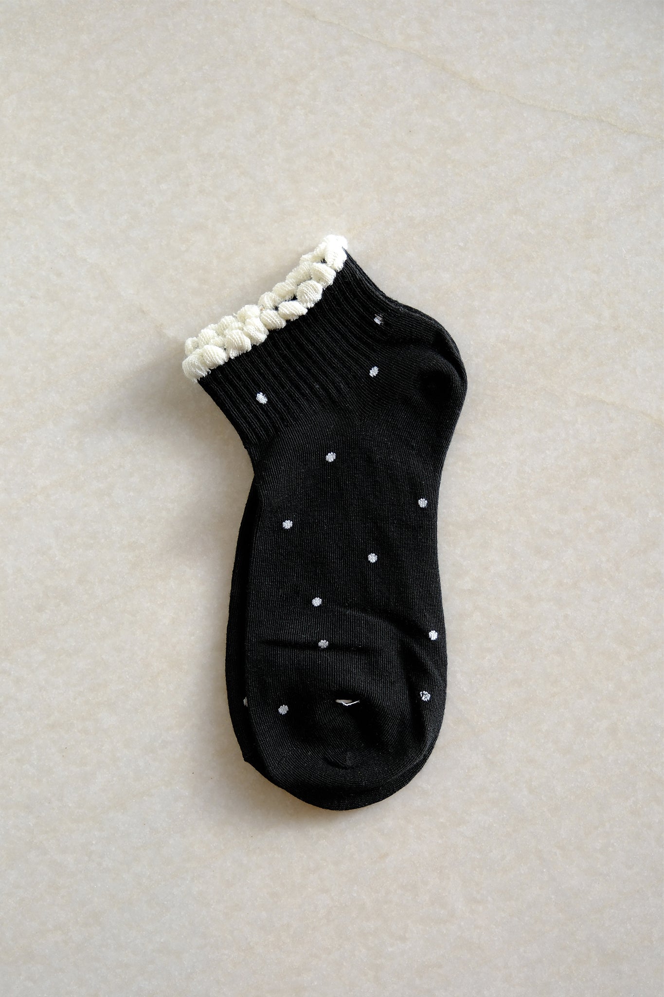 Chic black polka dot socks from Larrea Cove's new arrivals, perfect for adding playful charm to any ensemble.