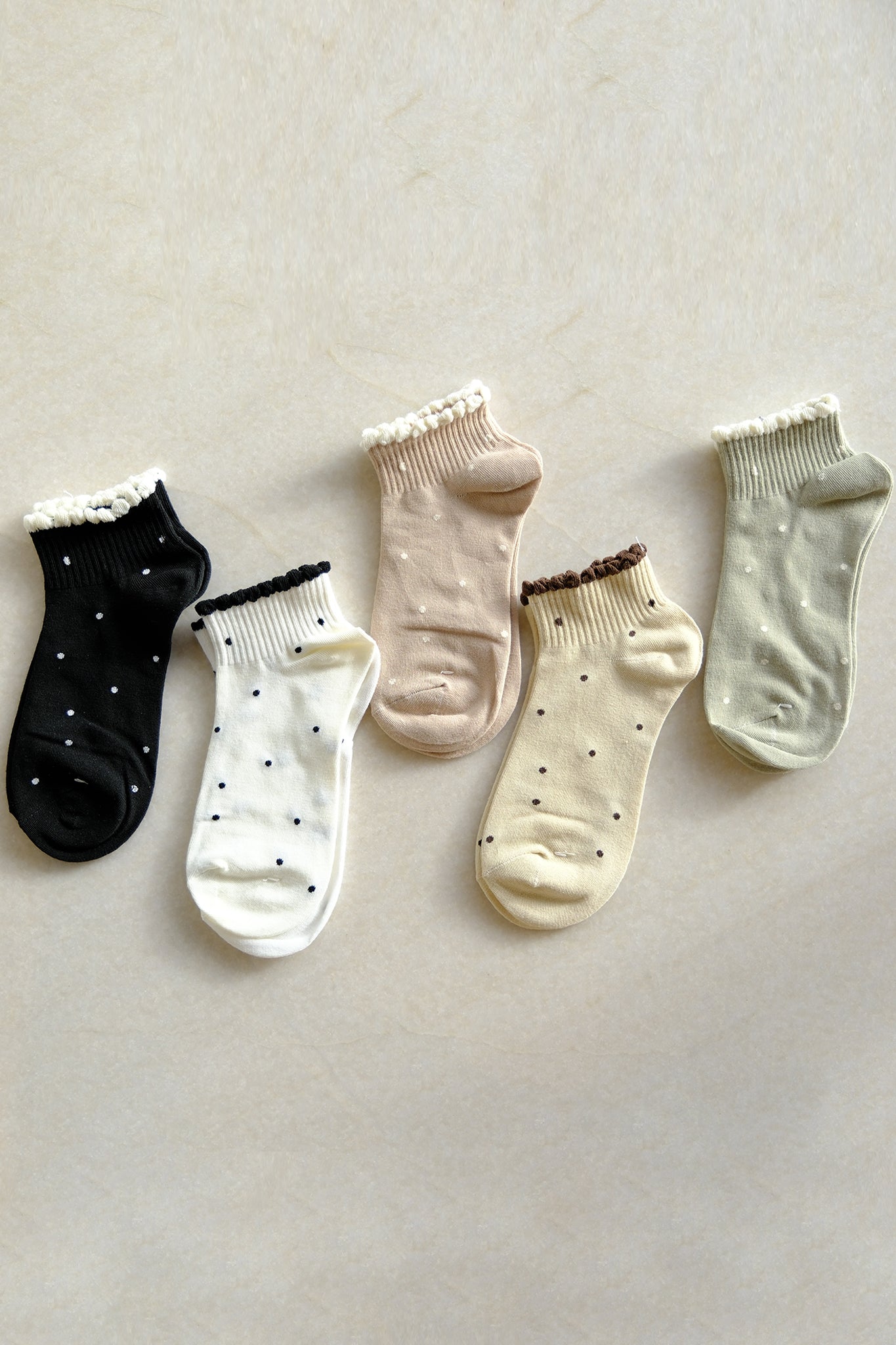 Charming polka dot socks in new arrivals, perfect for a playful touch to boho coastal outfits with Larrea Cove.