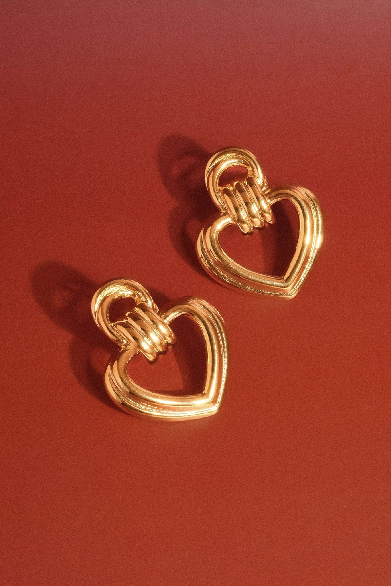 Heart hoops in yellow gold radiate a boho coastal charm, perfect for Larrea Cove's jewelry collection and new arrivals.