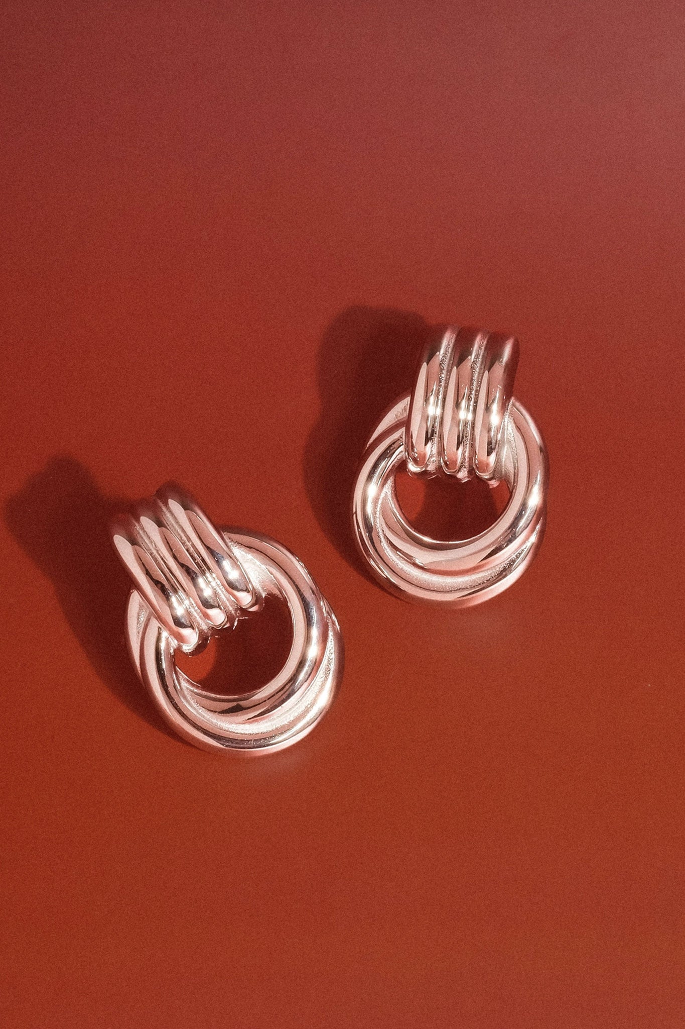 Silvery double knot earrings from Larrea Cove's new arrivals, embodying a boho coastal charm for jewelry enthusiasts
