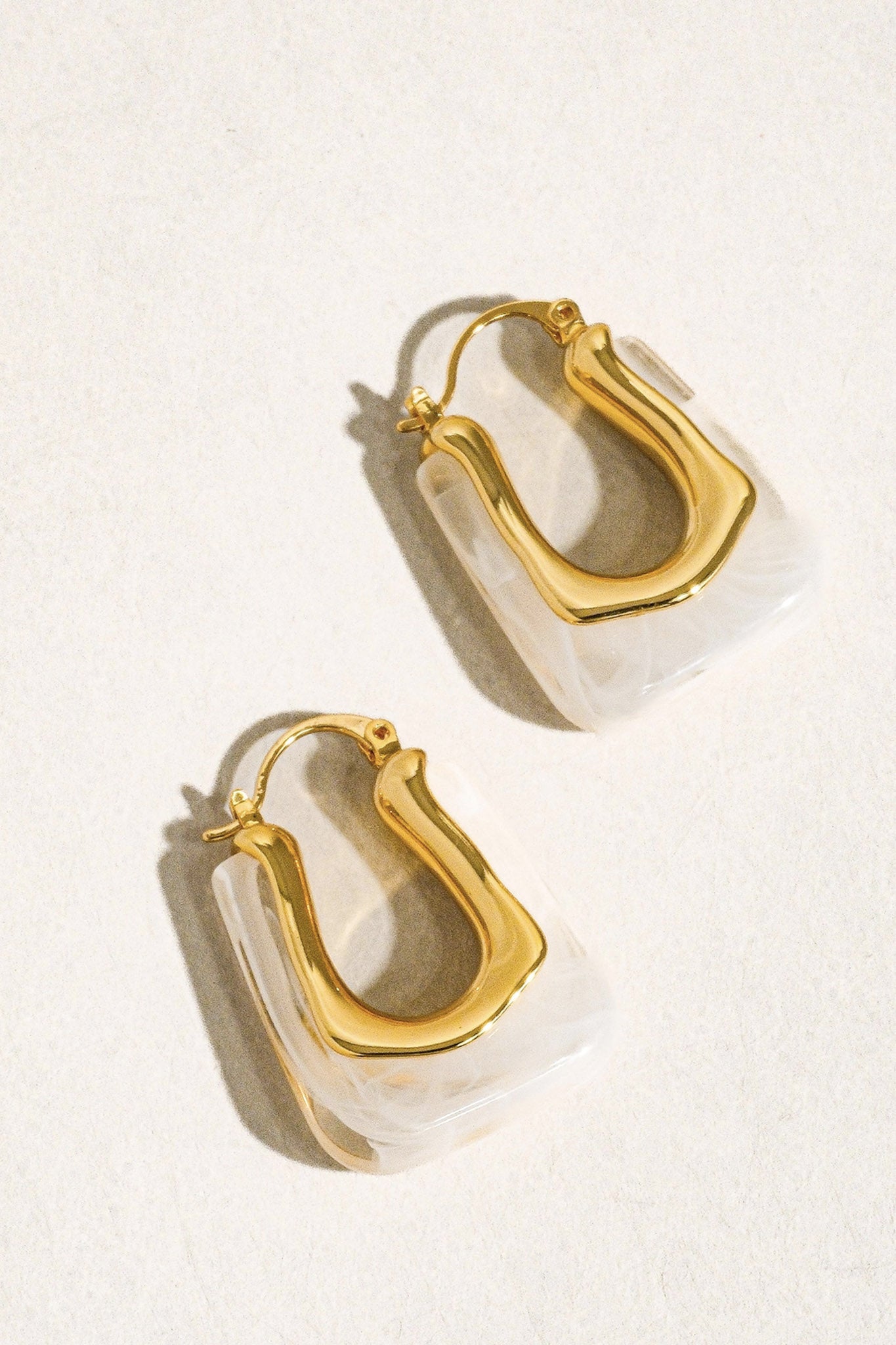 Elegant U-shaped boho hoop earrings in white, embodying Larrea Cove's coastal spirit from the new-arrivals jewelry collection.