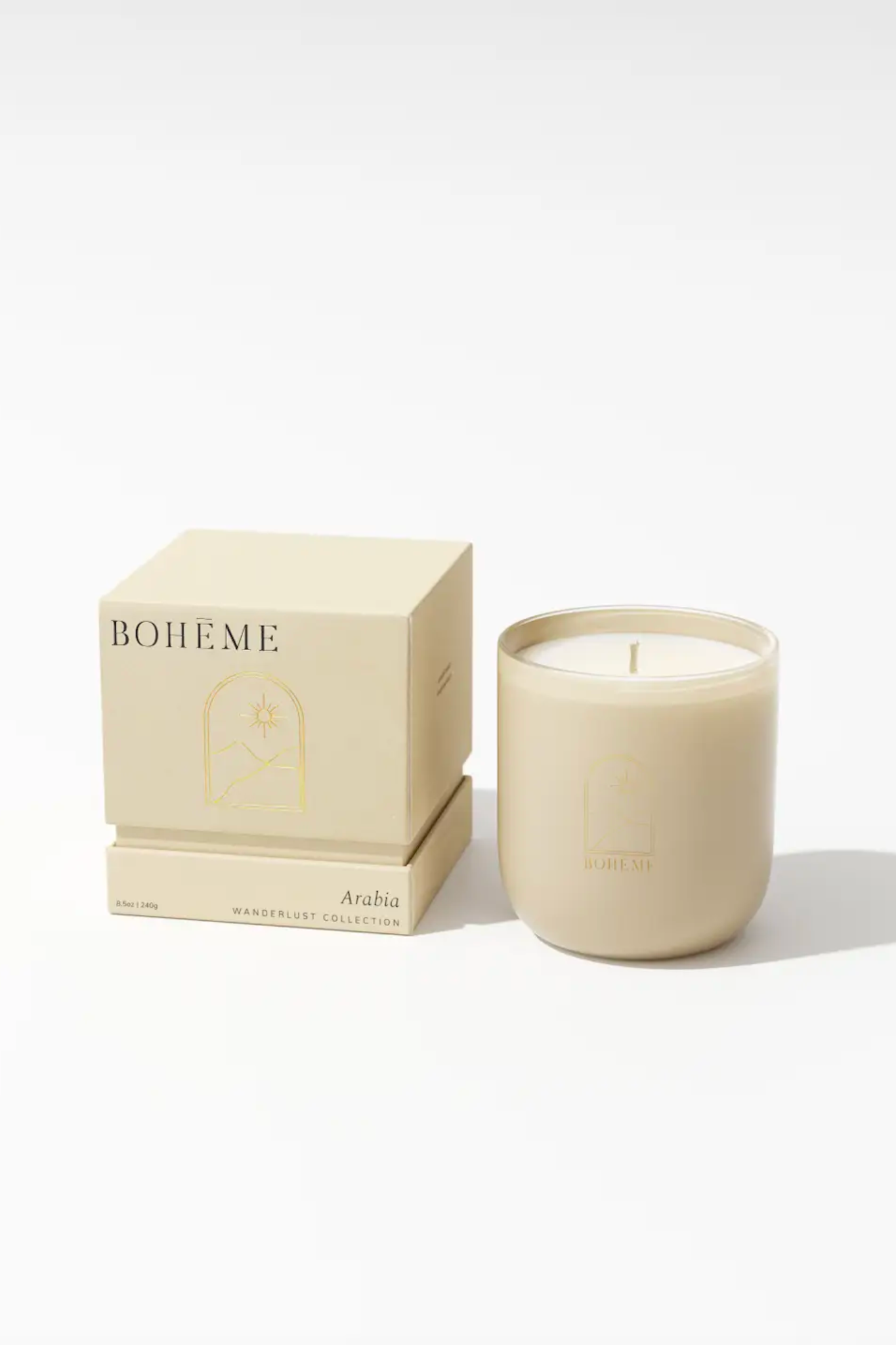 A Boheme Arabia Candle by Boheme, featuring a sleek design. The candle is made from natural wax with a cotton wick and comes in a glass container. The fragrance notes include cassis, thyme, bergamot, cypress, violet, sandalwood, oud, amber, saffron, labdanum, and musk. It is vegan, phthalate-free, and handmade in the USA. The candle has an approximate burn time of 50 hours.