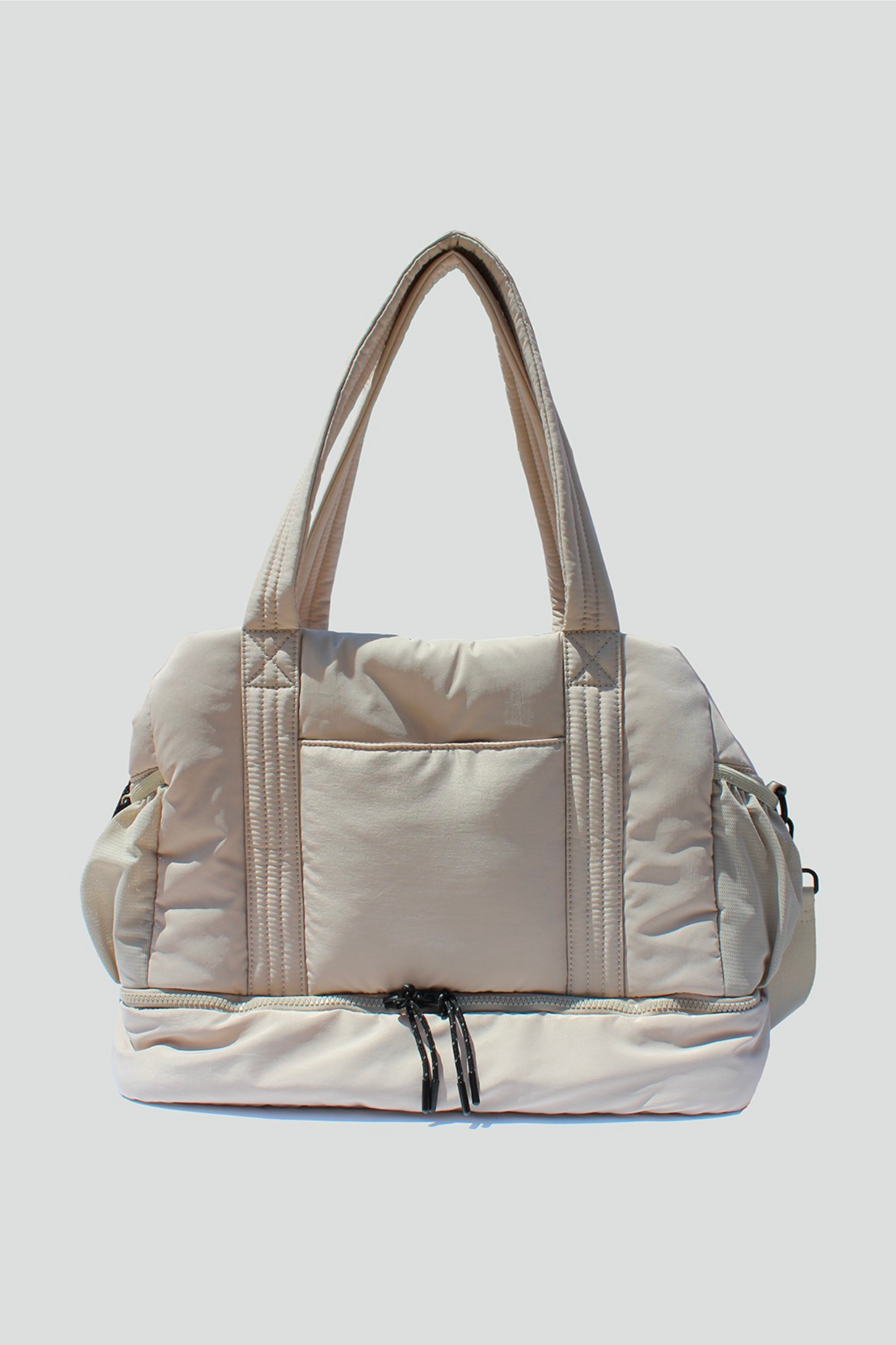 View 1 of Brooke Puffy Duffle Bag in Ivory, a Bags from Larrea Cove. Detail: 
Introducing Brooke – t...