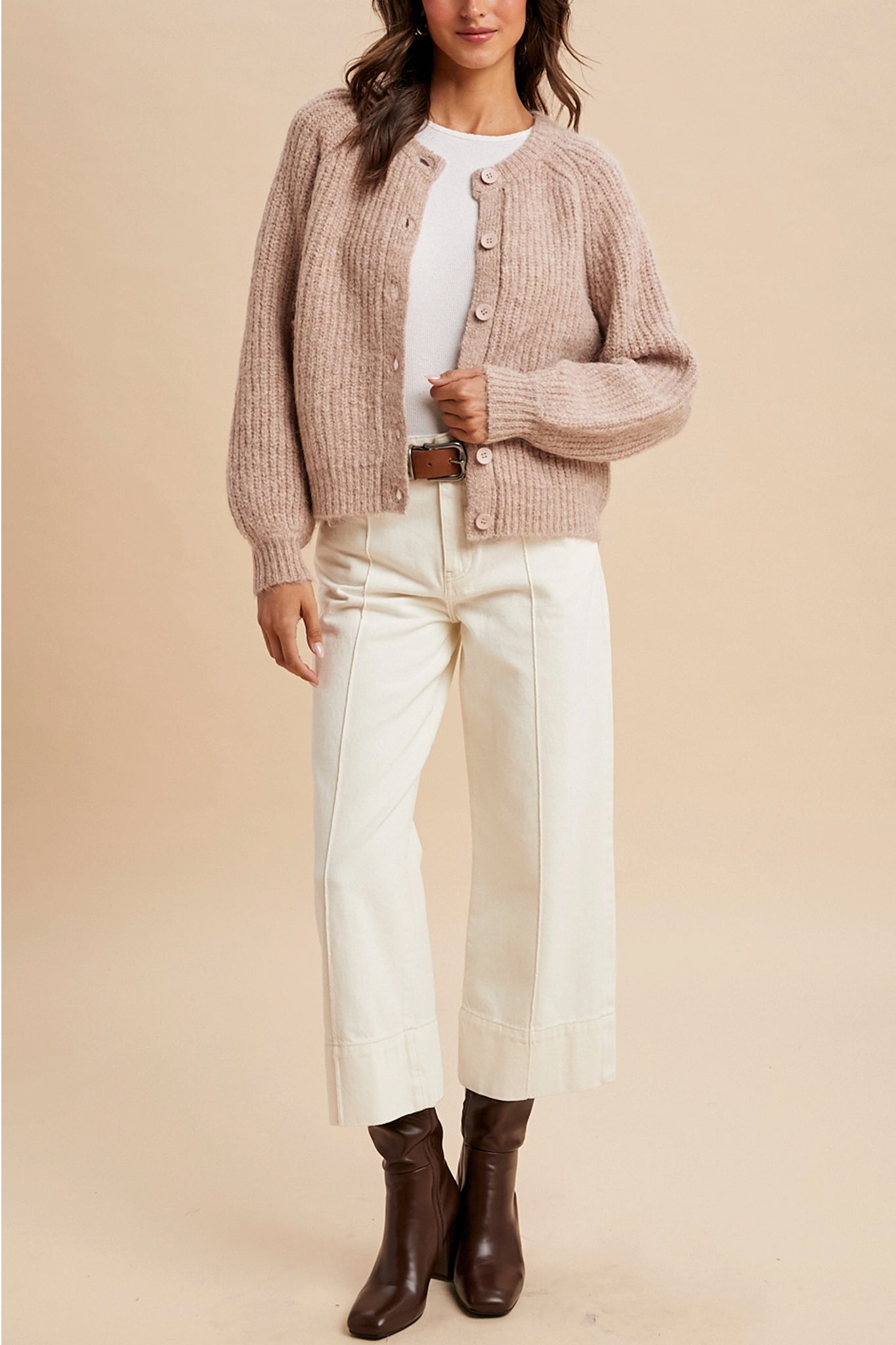 Dusty rose knit cardigan exudes boho charm, perfect for layering in coastal breezes. Larrea Cove outerwear collection.