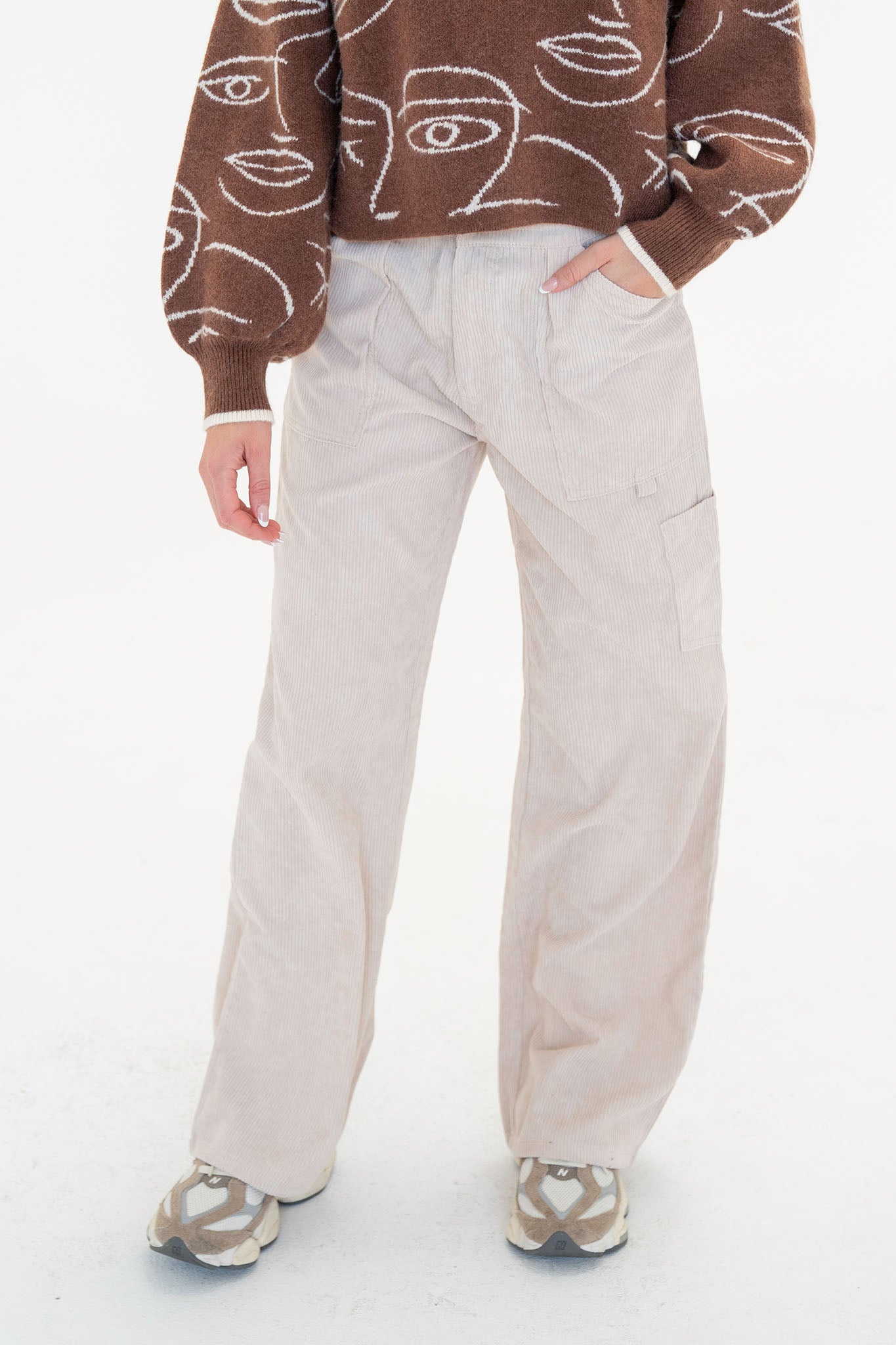 A pair of Corduroy Cargo Pants by Larrea Cove, featuring a pleated front, banded elastic waist, and button closure with zip fly. The pants are made from 100% polyester and are styled for a relaxed fit, suitable for casual wear. The model is displayed wearing the pants, standing at 5'8" with bust, waist, and hip measurements of 30", 24", and 35" respectively.