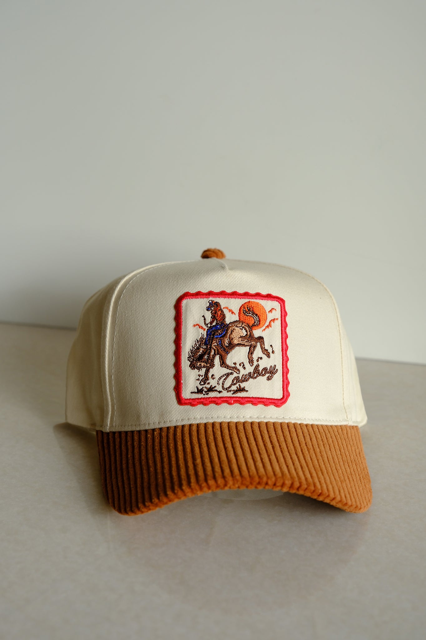 Embrace the boho coastal vibes with Larrea Cove's cowboy corduroy brim baseball cap in rich cognac, a perfect accessory from our hats collection.