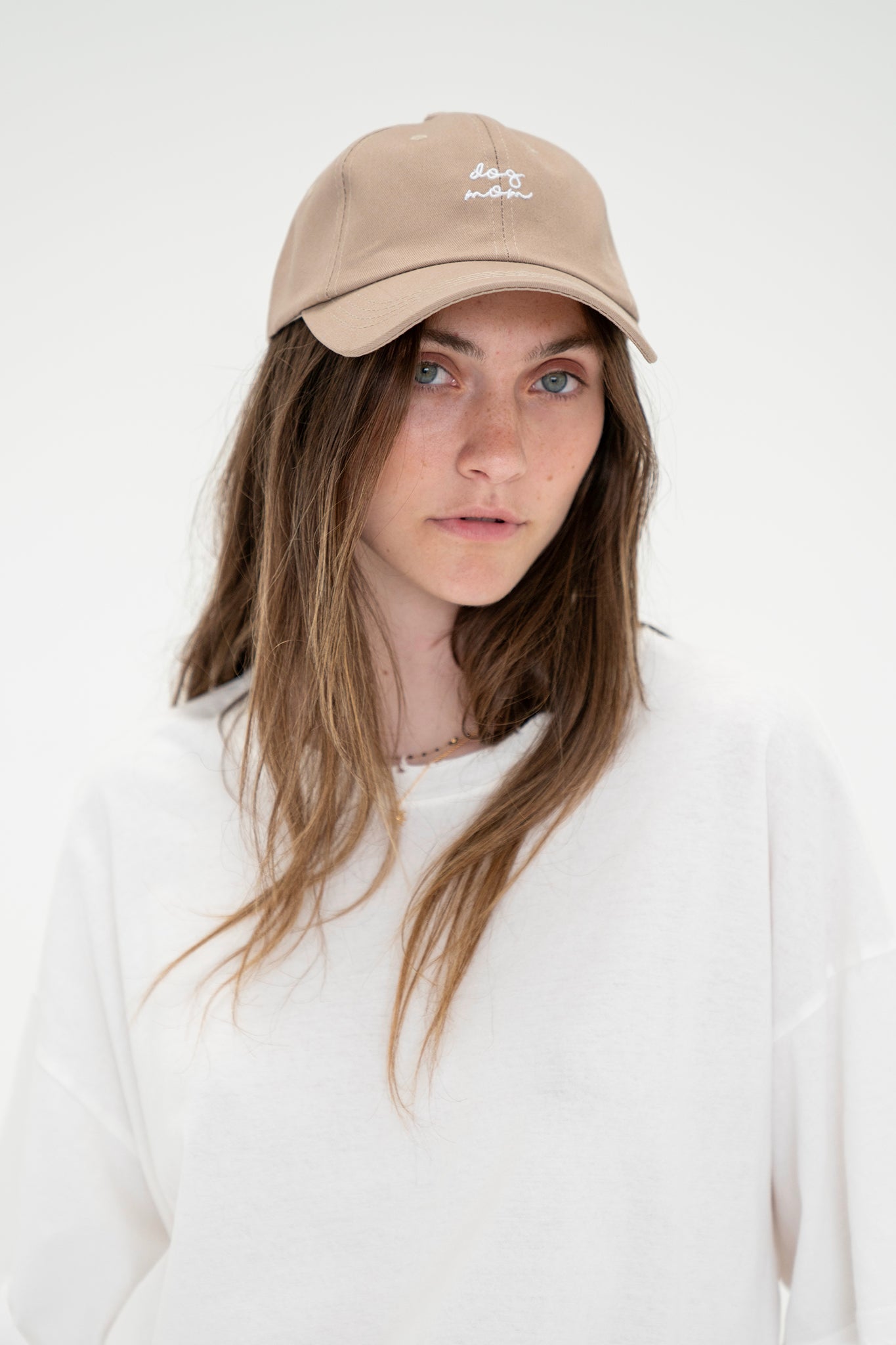 View 1 of Dog Mom Hat in Khaki, a Hats from Larrea Cove. Detail: Keep cool and cozy in the Dog Mom Hat! This cute accessory is perfect for any d...