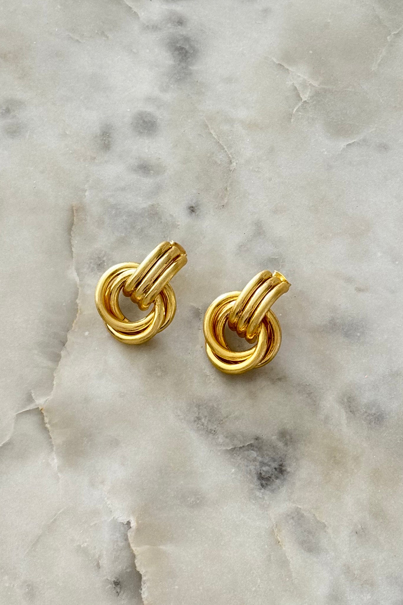 Matte gold double knot earring from Larrea Cove's summer wanderlust collection, perfect for adding a boho coastal touch.