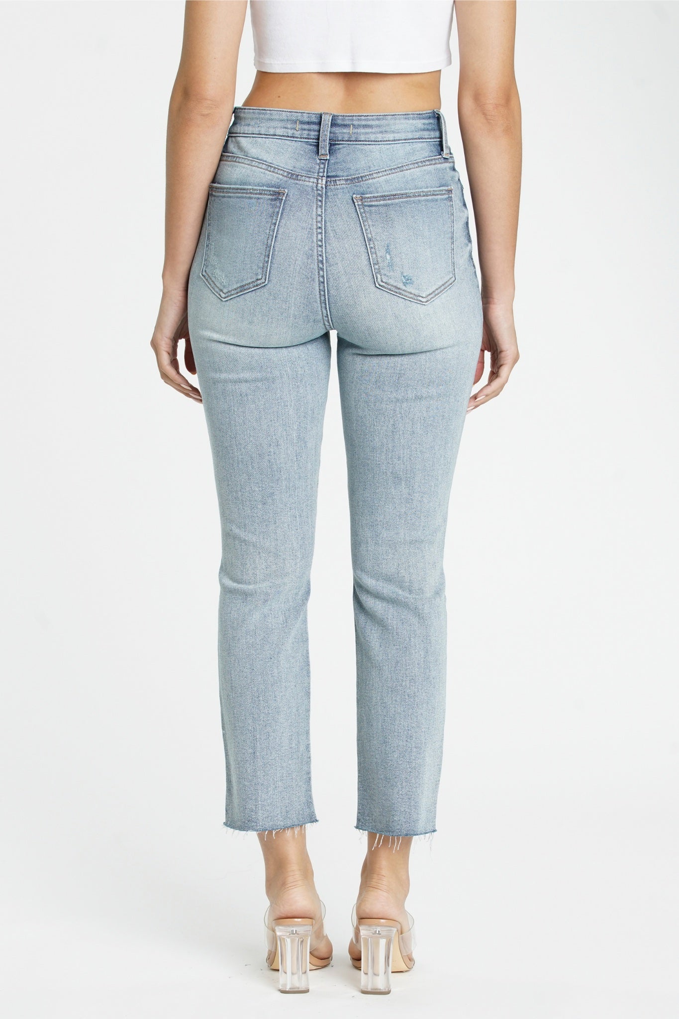 Eunina Ally Straight Jeans in Saguaro, featuring a light green color. The jeans have a classic straight-leg fit and are styled with sunglasses placed nearby. The product is tagged with various categories, including 'Jeans' and 'Pants,' and is noted as new with a restock date of March 2024.