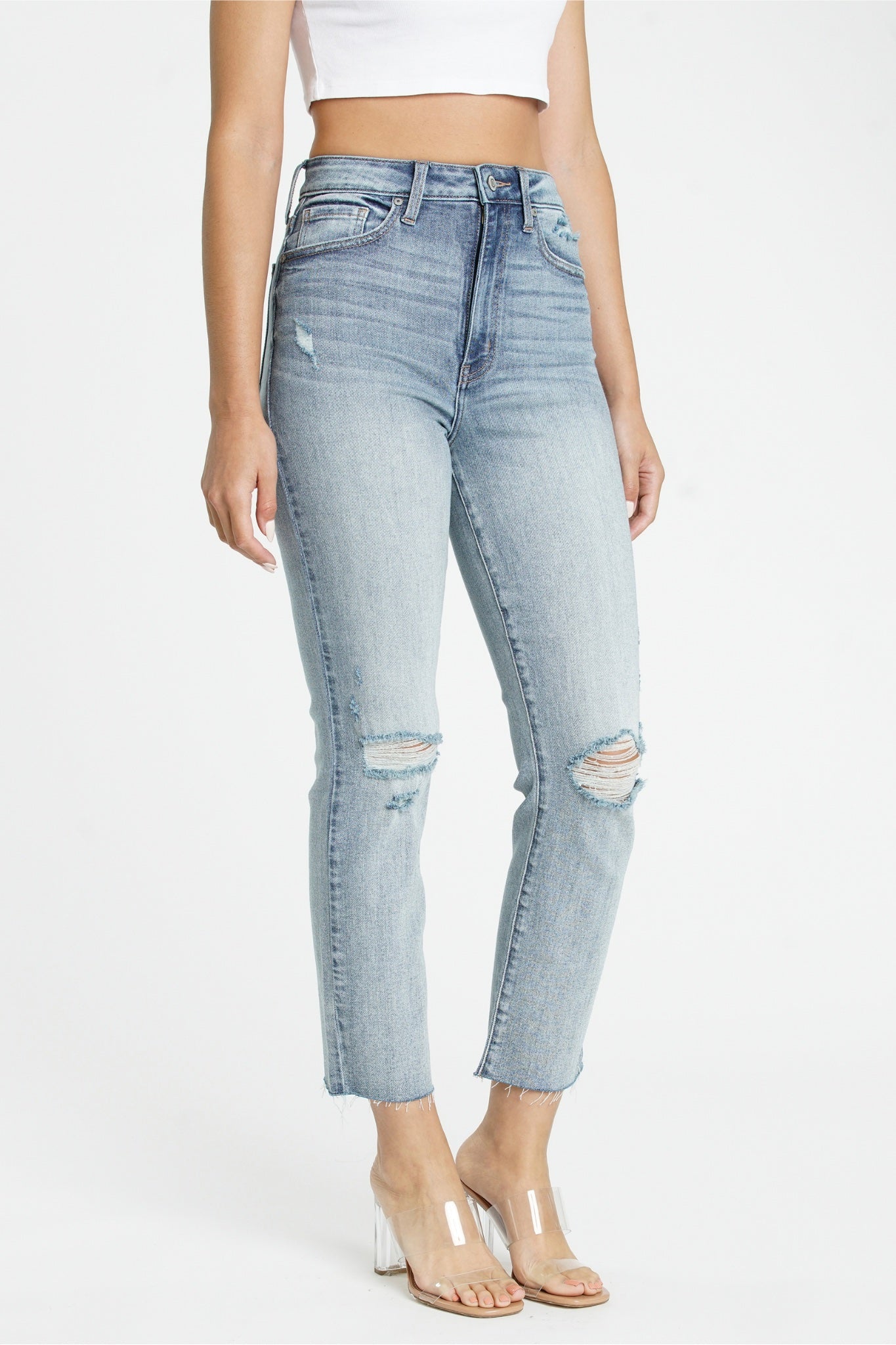 Eunina Ally Straight Jeans in Saguaro, featuring a light green color and a straight leg design. The jeans are displayed on a neutral background, showcasing their casual style. Accompanying the jeans are sunglasses, adding a trendy accessory element.