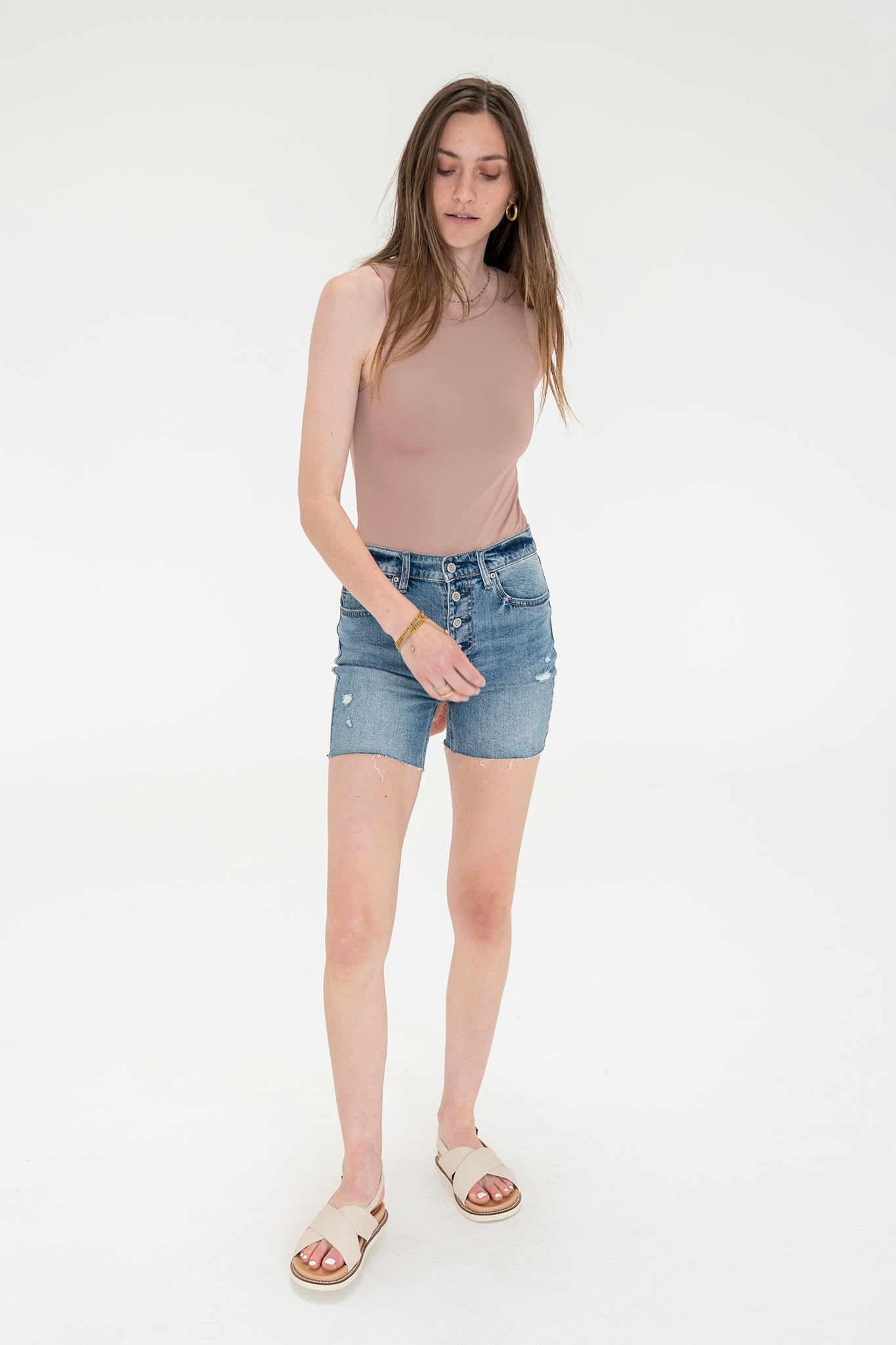 A pair of Eunina Kailey biker shorts in a Camissonia print, displayed against a neutral background. The shorts feature a fitted design suitable for casual wear. Accompanying the shorts are a stylish pair of sunglasses, emphasizing a trendy summer look.