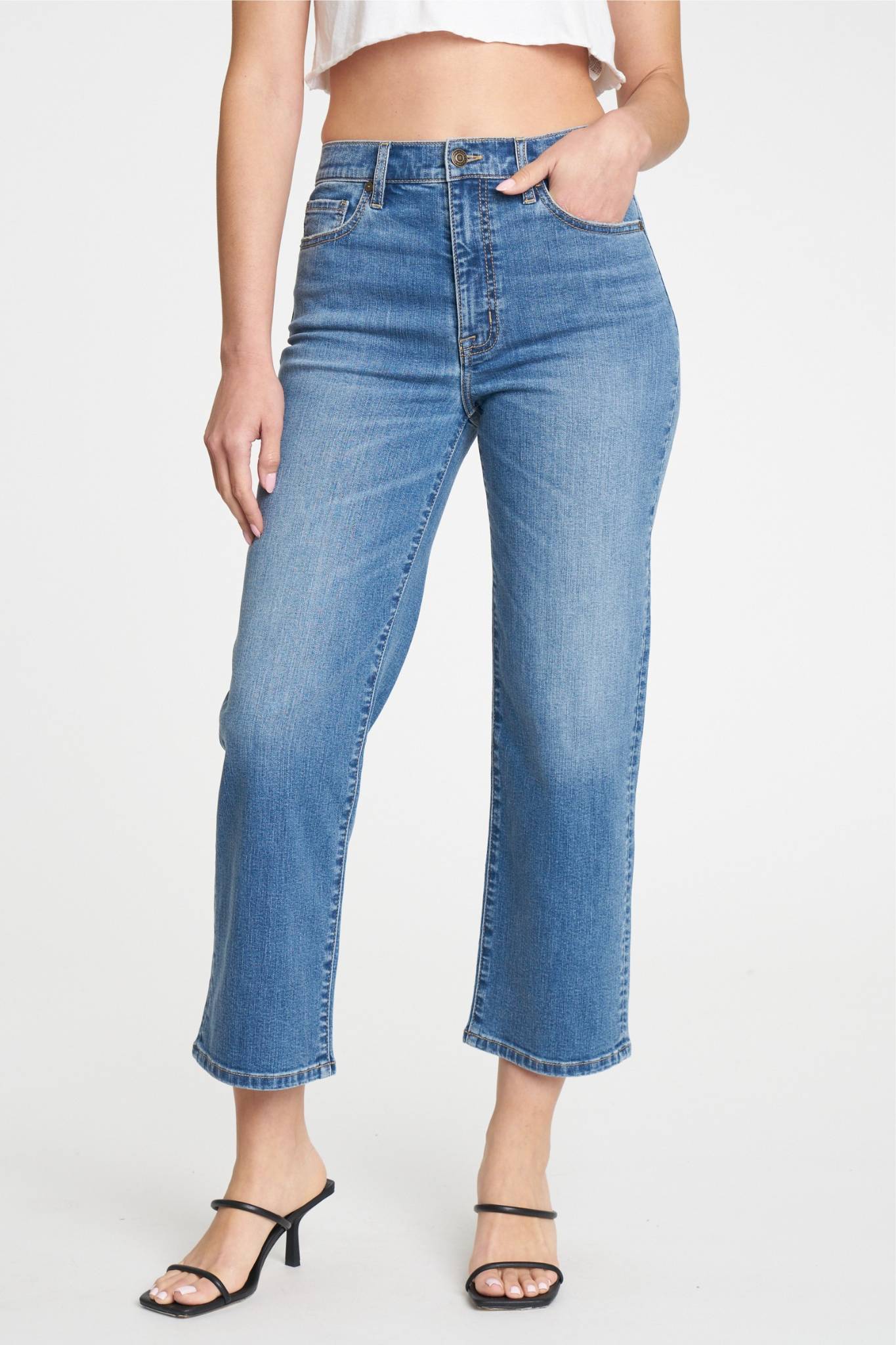 A pair of Eunina Dawn wide-leg jeans in Aliso, showcasing a relaxed fit with a high waist and light denim wash. The jeans feature a classic five-pocket design. The image also includes a pair of stylish sunglasses, complementing the casual look. Perfect for summer outfits.