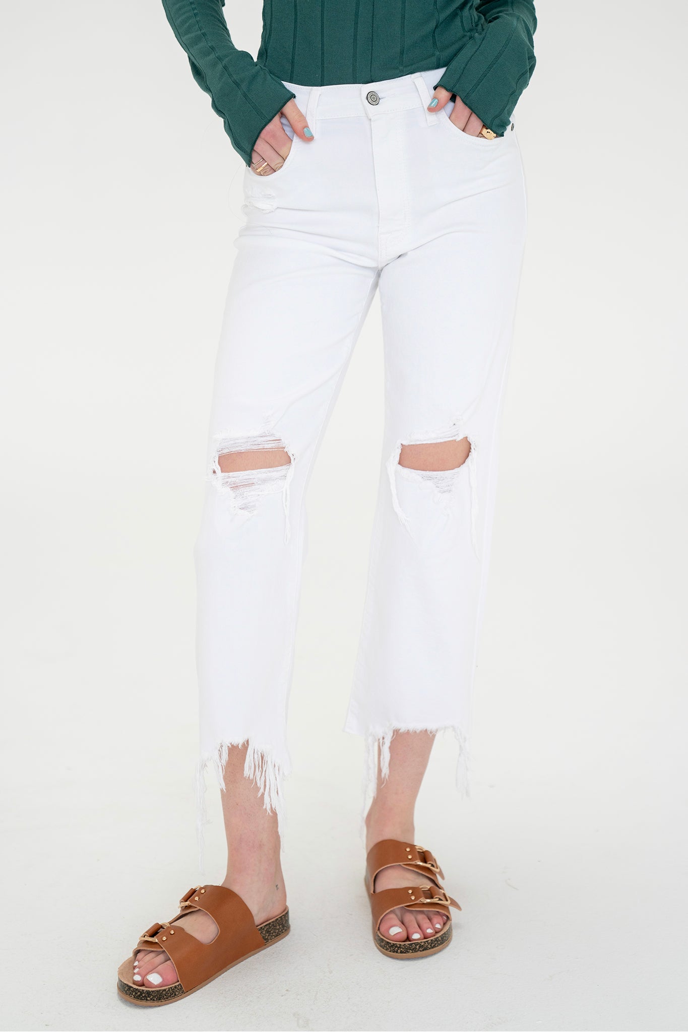 A pair of Eunina Dawn Wide Leg Jeans in a Datura color, displayed against a neutral background. The jeans feature a high-waisted design with wide legs, emphasizing a relaxed and trendy silhouette. Accompanying the jeans are stylish sunglasses, enhancing the spring fashion aesthetic. The image promotes the jeans as a new product for March 2023, available on sale.