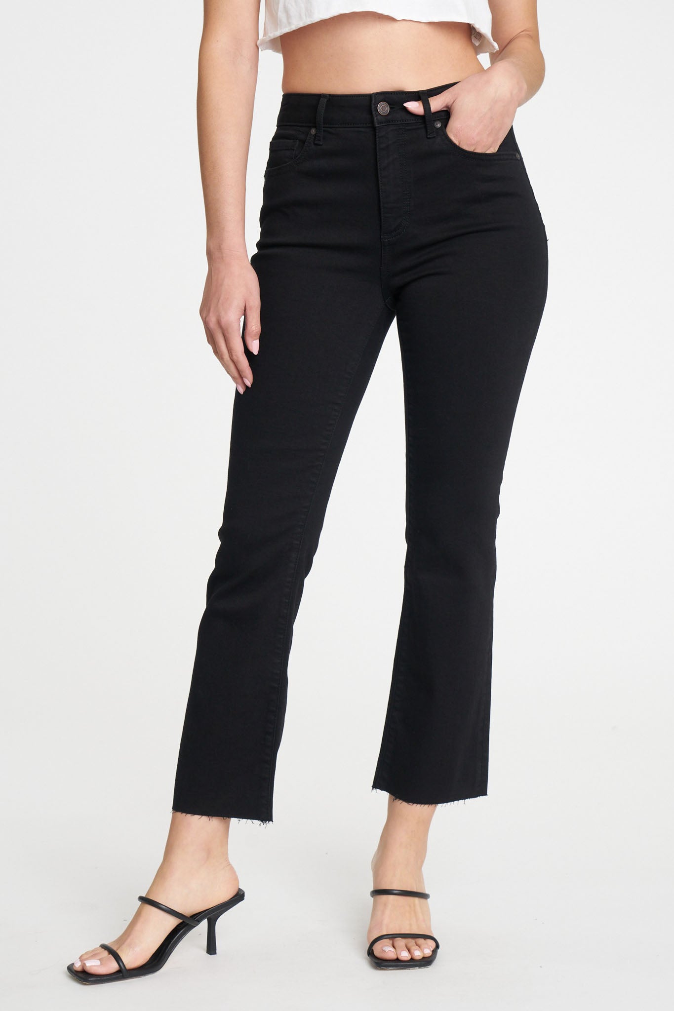 A pair of Eunina Emery Cropped Boot Jeans in a deep Desert Night color, featuring a stylish cropped cut and a bootleg silhouette. The jeans are showcased against a neutral background, highlighting their design. Accompanying the jeans are trendy sunglasses, adding a fashionable touch to the overall look. The image suggests a fall fashion theme, emphasizing new arrivals for May 2024.