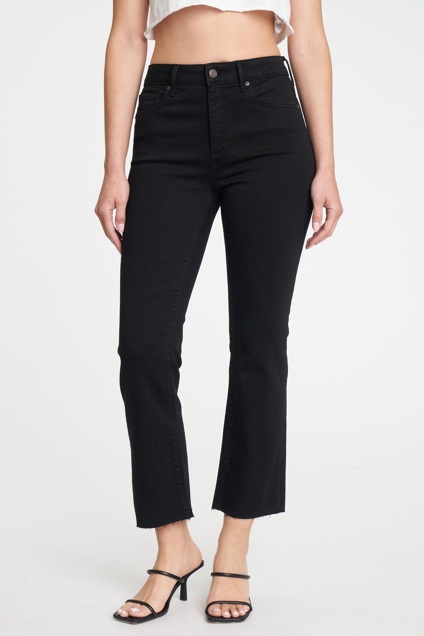 Eunina Emery Cropped Boot Jeans in Desert Night displayed on a flat surface. The jeans feature a dark, rich color with a cropped boot cut and subtle detailing. Accompanying the jeans are stylish sunglasses, showcasing a trendy fall look. The image is tagged for promotional use with various categories and vendor information.
