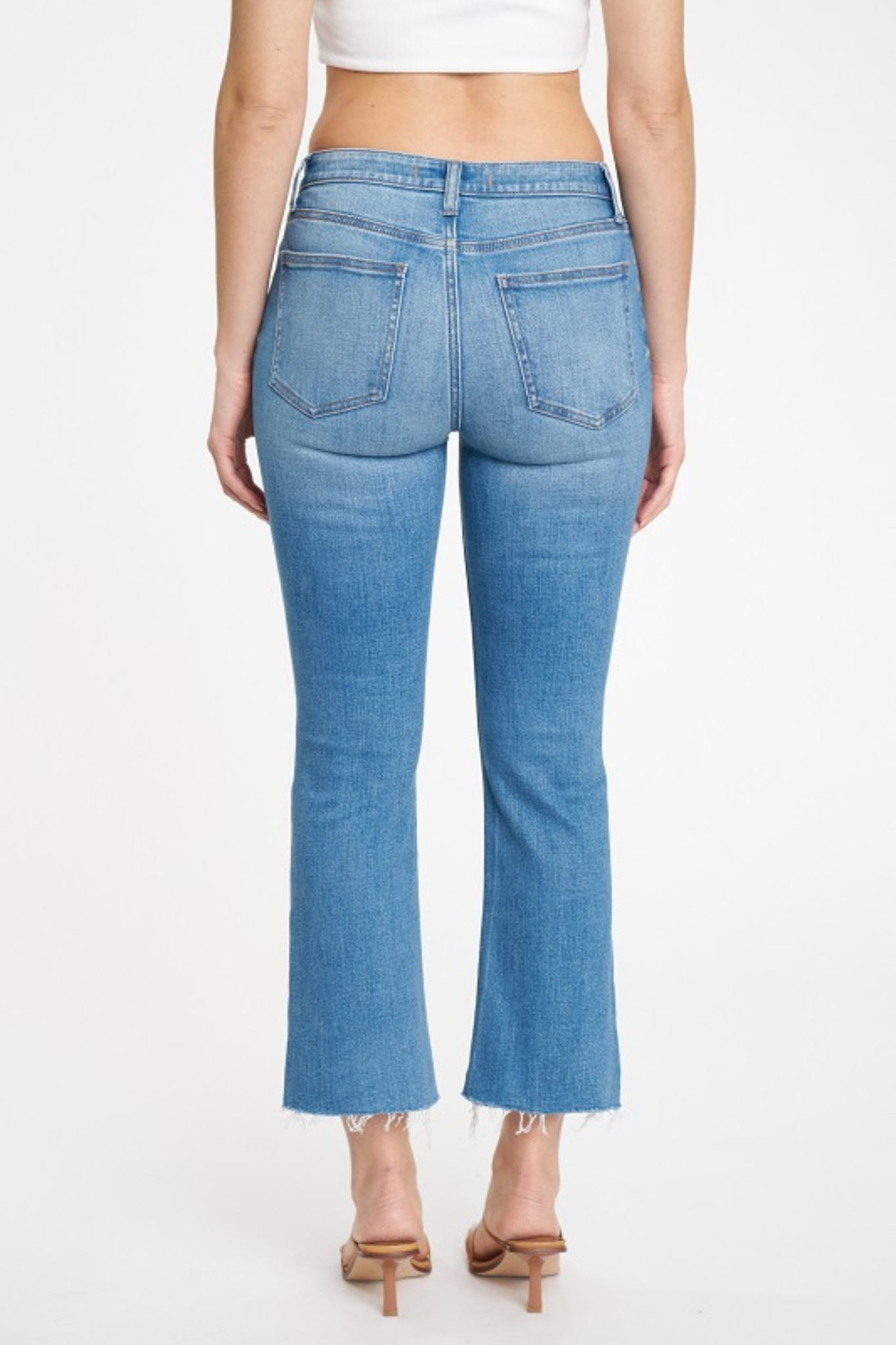 Eunina Emery Cropped Boot Jeans in Woods Cove, featuring a mid-rise fit and a stylish bootcut design. The jeans are paired with sunglasses, showcasing a casual, trendy look. Perfect for spring 2024 fashion.