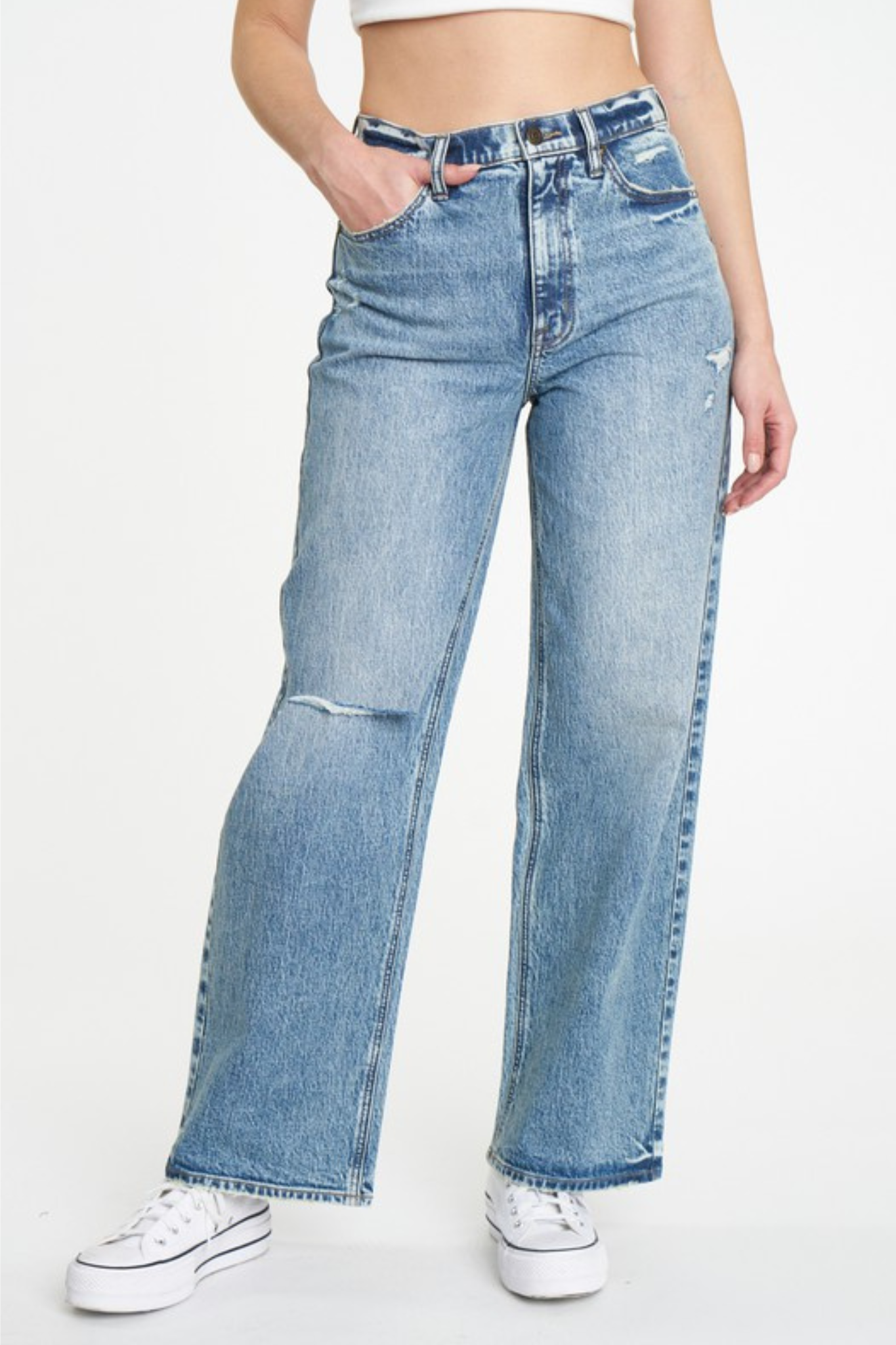 A pair of Eunina Ryder ultra high rise baggy jeans in medium wash denim, featuring distressed details at the knees and a relaxed fit. The jeans have a five-pocket design, belt loops, and a hidden zip fly with button closure, displayed against a neutral background.