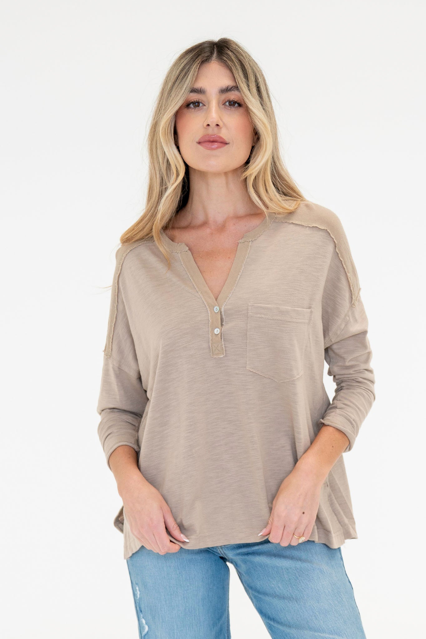 View 1 of Freesia Henley in Taupe, a Tops from Larrea Cove. Detail: Harness the power of effortless style with the Freesia Henley in Taupe.