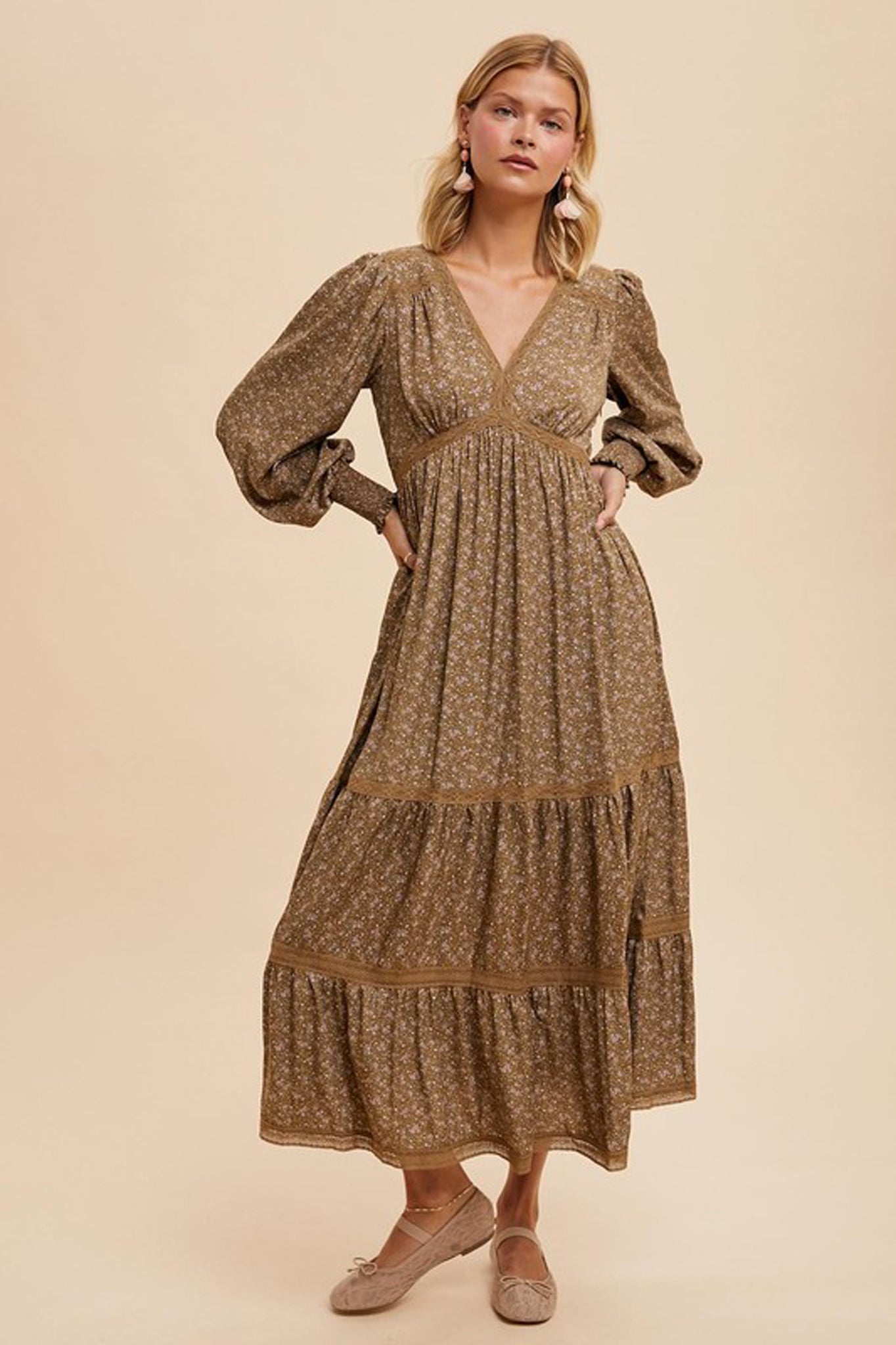 Lace trim floral maxi dress by Larrea Cove, featuring a flowing design with a vibrant floral pattern. The dress is styled with sunglasses, set against a neutral background.