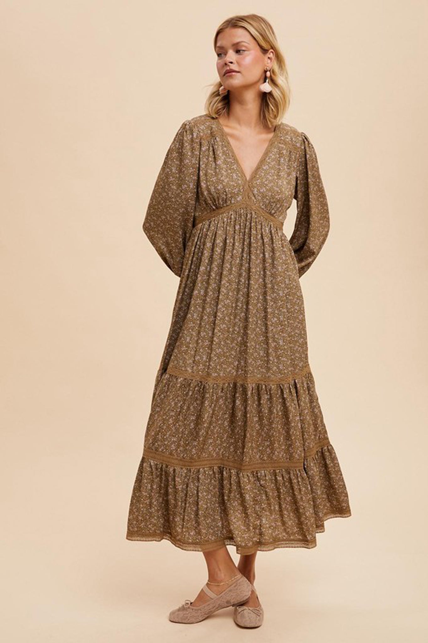 Lace trim floral maxi dress by Larrea Cove, featuring a vibrant floral pattern and delicate lace detailing. The dress is styled with sunglasses, set against a neutral background. Ideal for Fall 2024 fashion.
