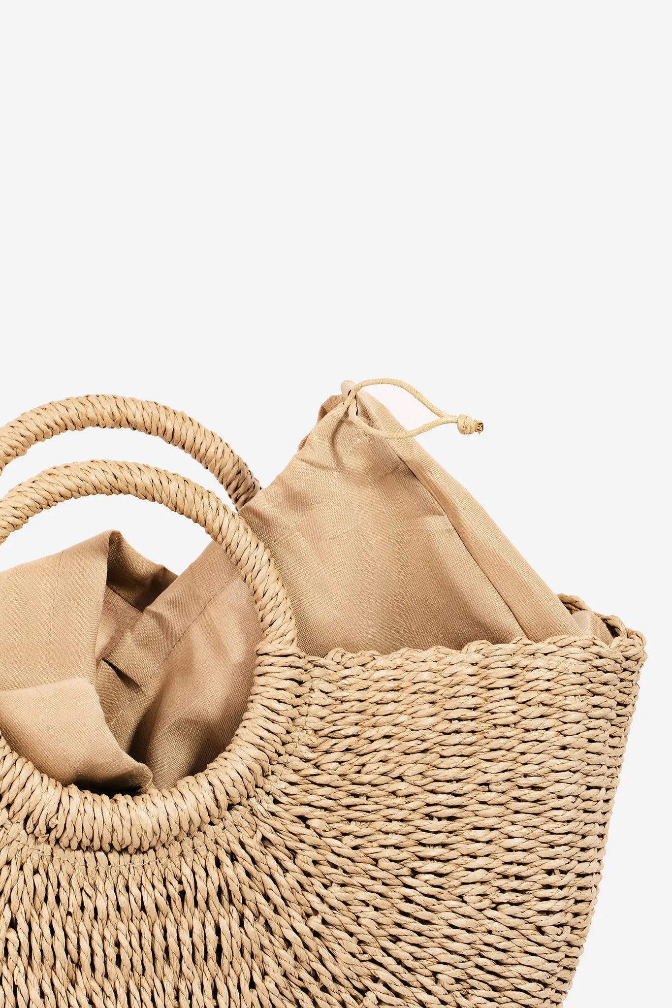 Tan Marra circle handle straw bag with top handle detail from Larrea Cove's new arrivals, perfect for boho coastal style.