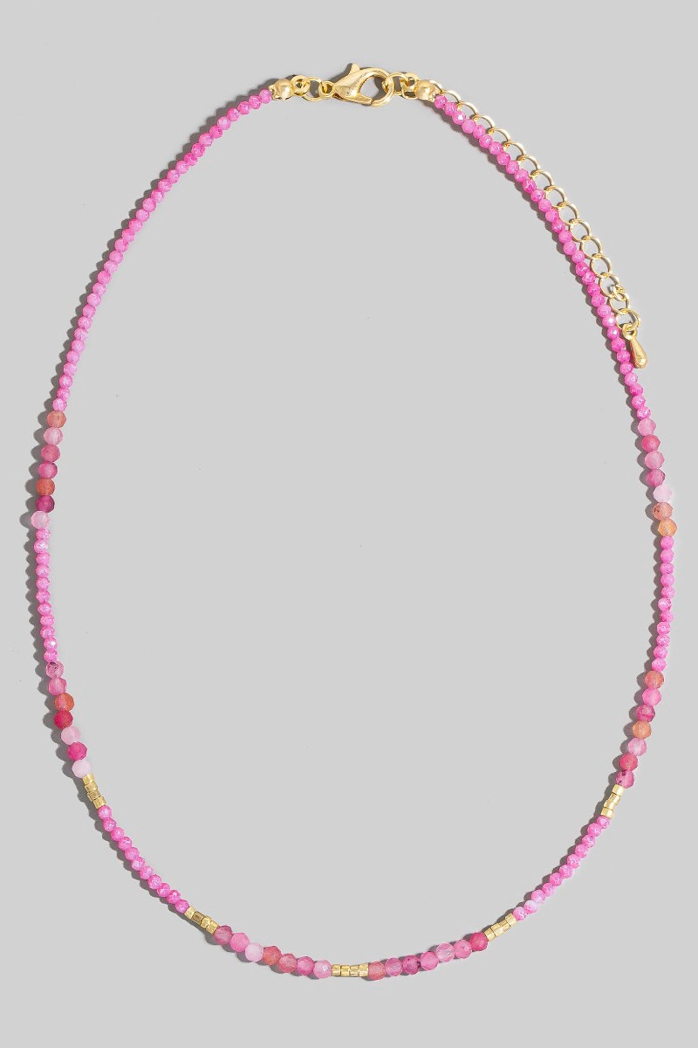 Larrea Cove's mixed beaded necklace in pink features delicate gold accents, embodying a boho coastal vibe for jewelry lovers.