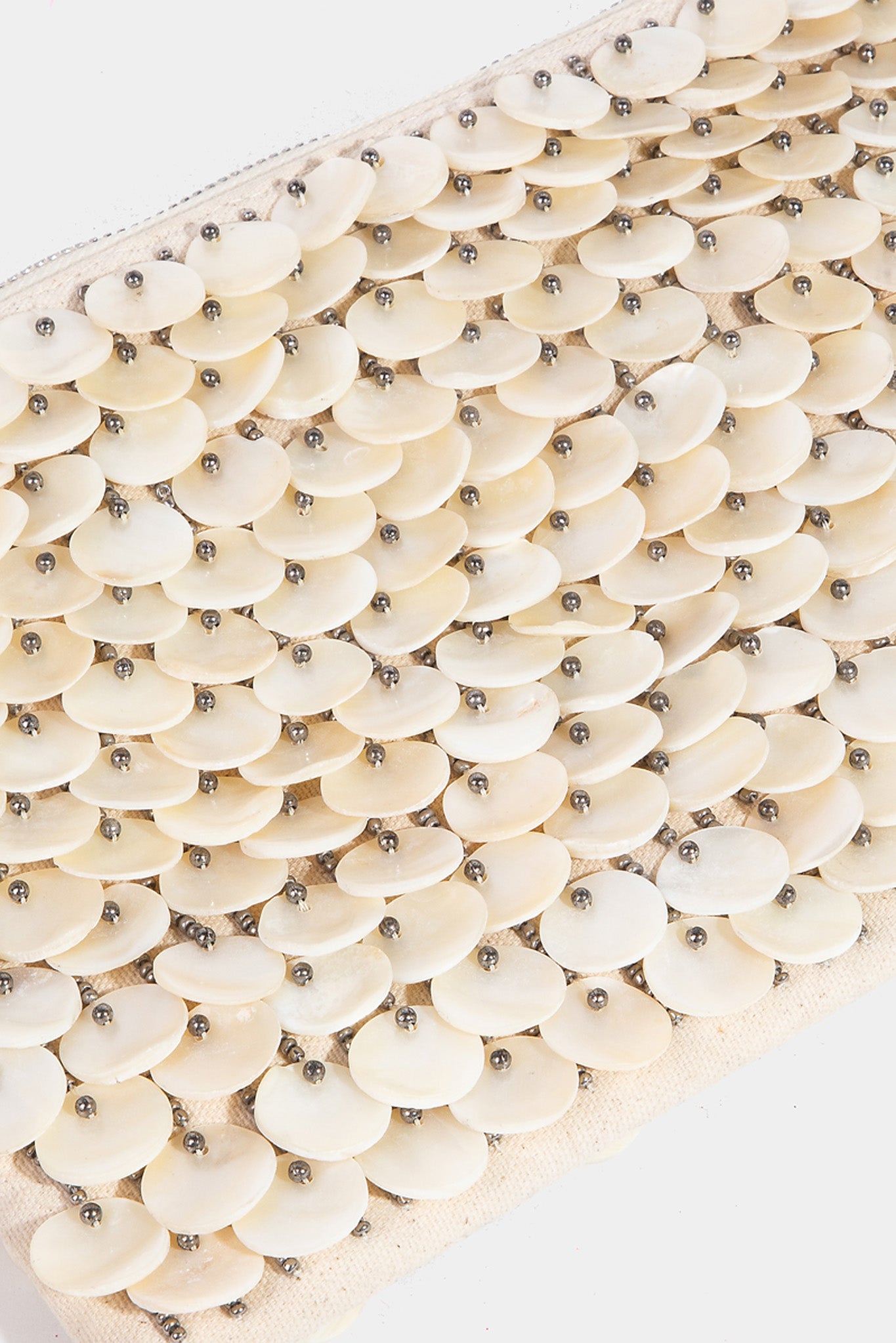 Handbag made from mother of pearl shell discs, designed by ANTIK KRAFT. The bag features a stylish and unique exterior with a glossy finish, perfect for summer. Accompanied by sunglasses, the handbag is part of the new Summer 2024 collection.