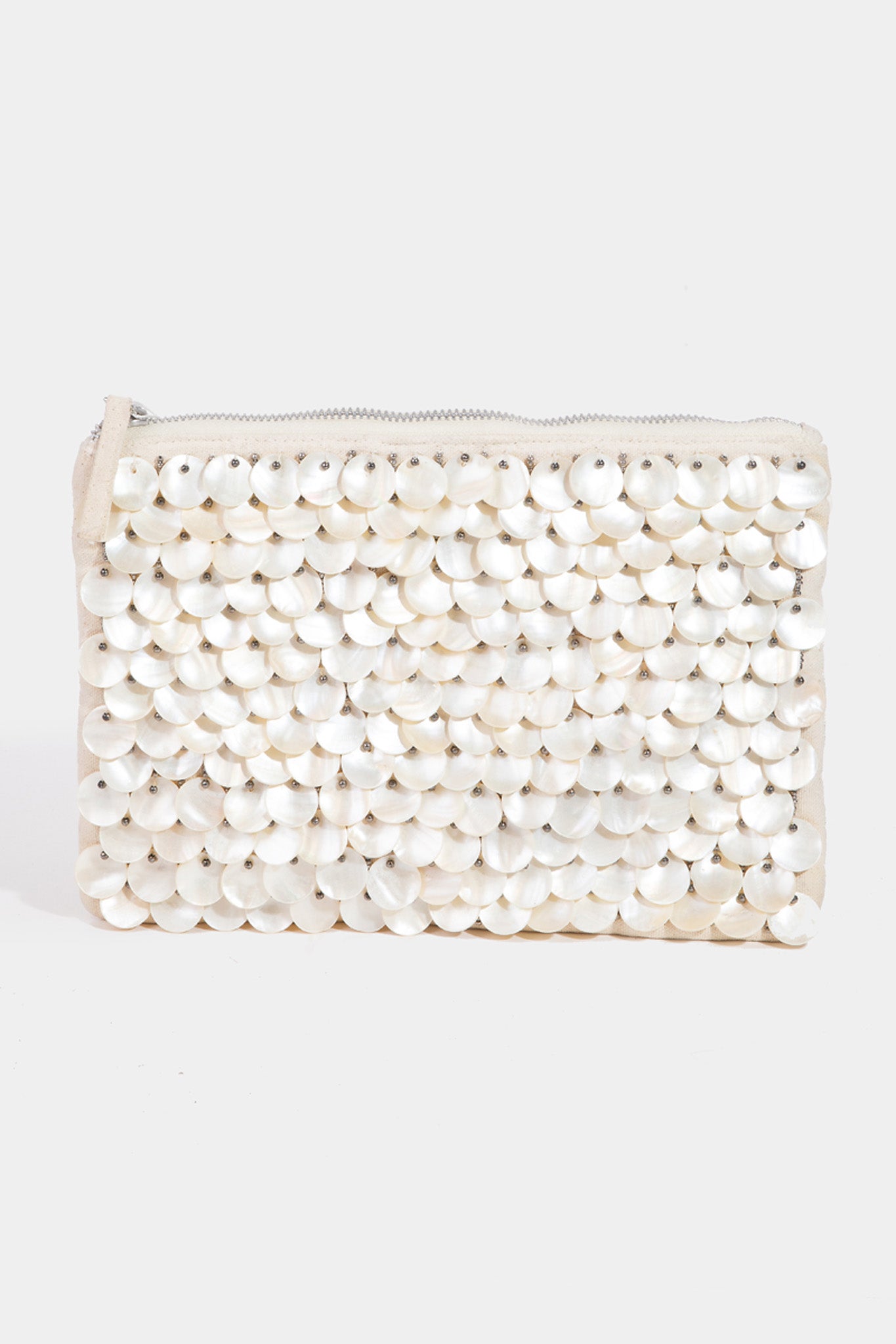 A stylish handbag made from mother of pearl shell discs, designed by ANTIK KRAFT. The handbag features an elegant, shimmering surface that reflects light beautifully, perfect for summer outings. It is paired with sunglasses, showcasing a chic accessory ensemble. The image represents a new product for July 2024, categorized under handbags in the apparel and accessories section.