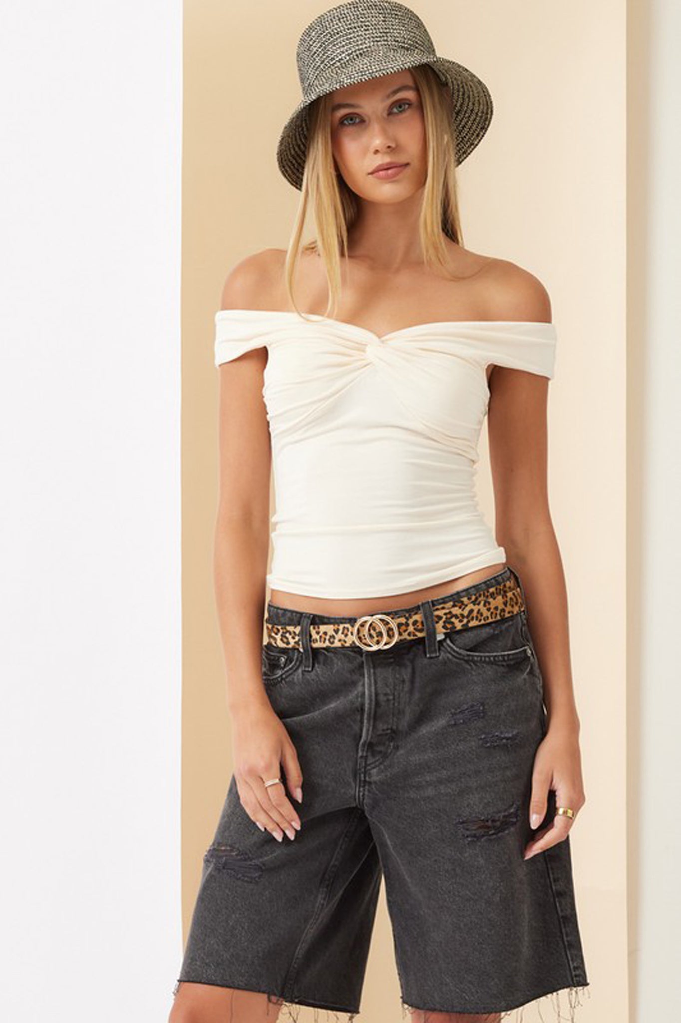 Off-shoulder cream top by Larrea Cove, featuring a relaxed fit and stylish design, perfect for fall. The top is paired with trendy sunglasses, showcasing a contemporary fashion look.