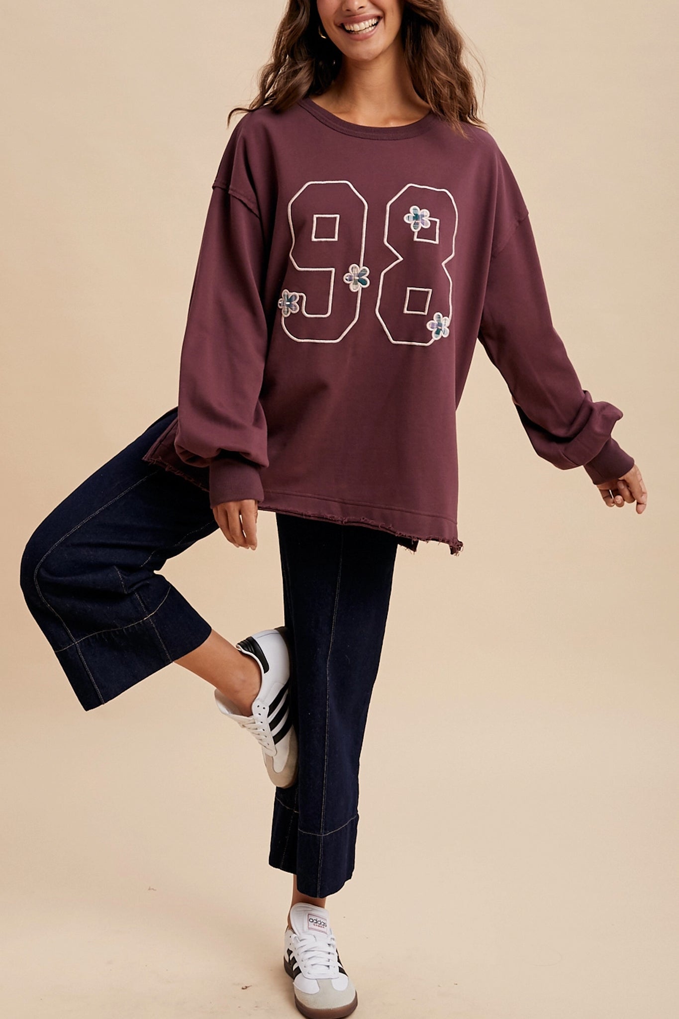 Cozy vintage varsity oversized pullover in rich plum, perfect for layering in Larrea Cove's boho coastal outerwear collection.