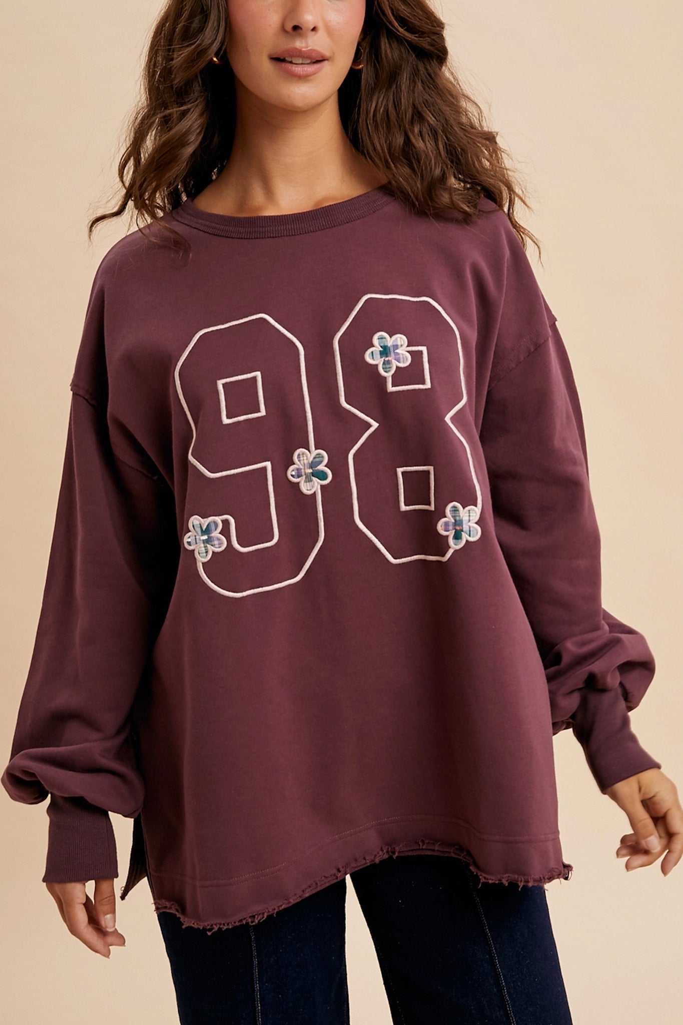 Embrace coastal boho vibes with Larrea Cove's vintage varsity oversized pullover in plum, perfect for effortless style in new arrivals.