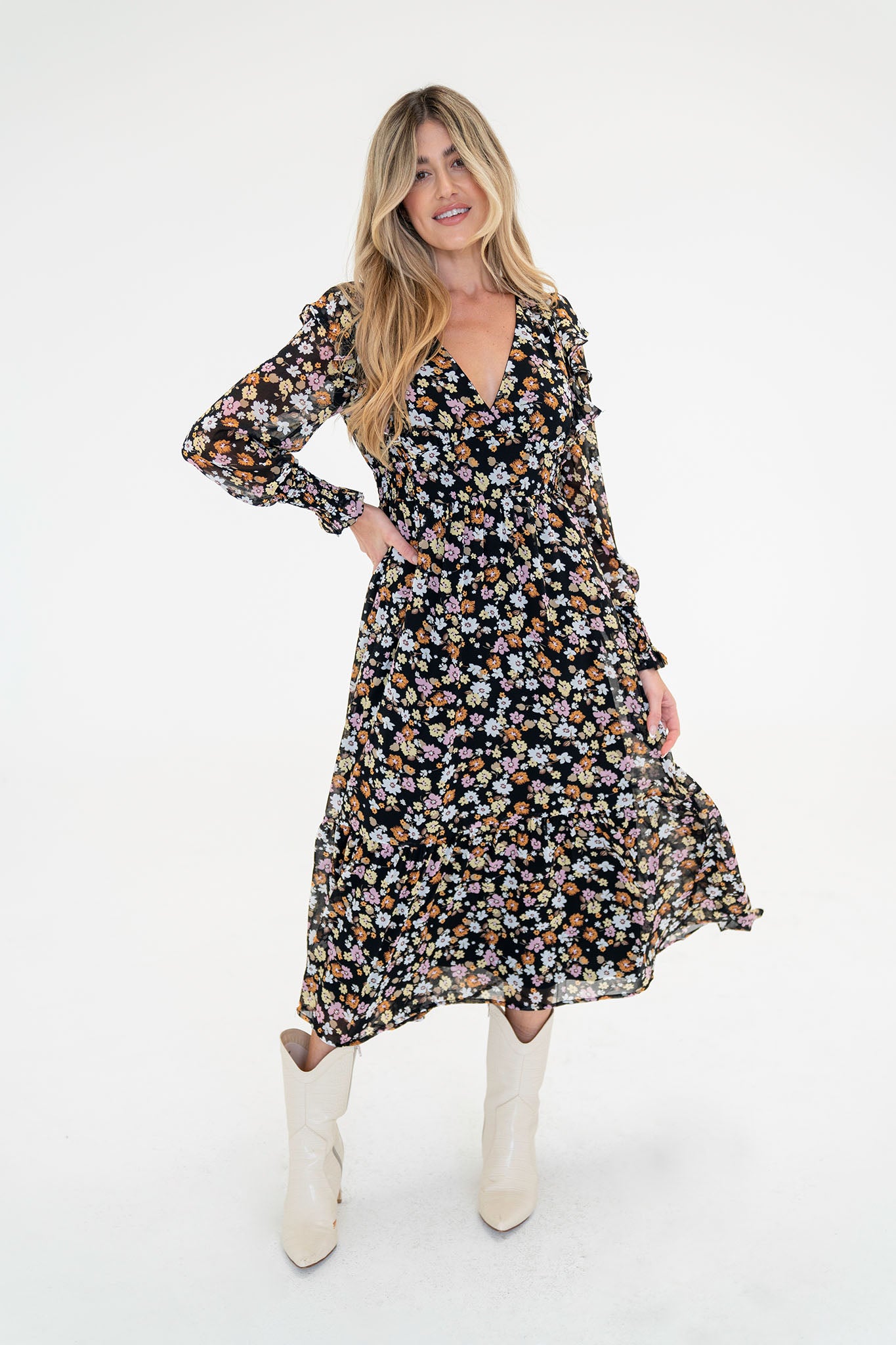 A floral midi dress featuring pansy patterns, designed by Larrea Cove. The dress is suitable for fall and is part of a last-chance sale. It is accompanied by stylish sunglasses, highlighting its fashionable appeal. The product is categorized under dresses in the apparel and accessories section.