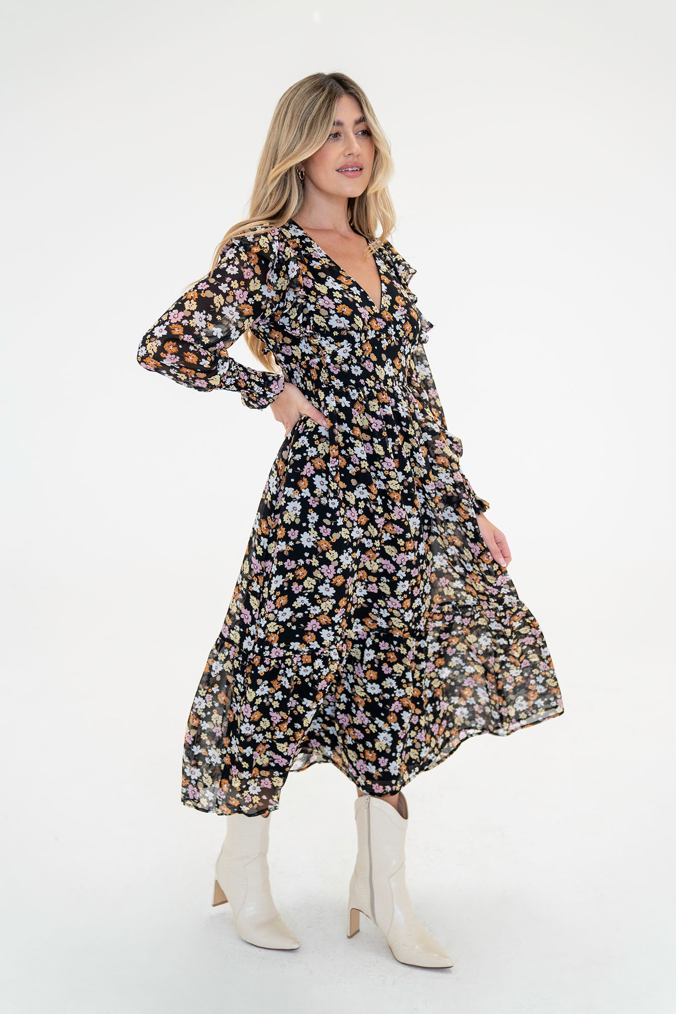 A floral midi dress featuring a pansy print, designed by Larrea Cove. The dress is suitable for fall and is part of a sale event. It is showcased alongside sunglasses, emphasizing a stylish outfit option. The image represents a new product released in September 2023.