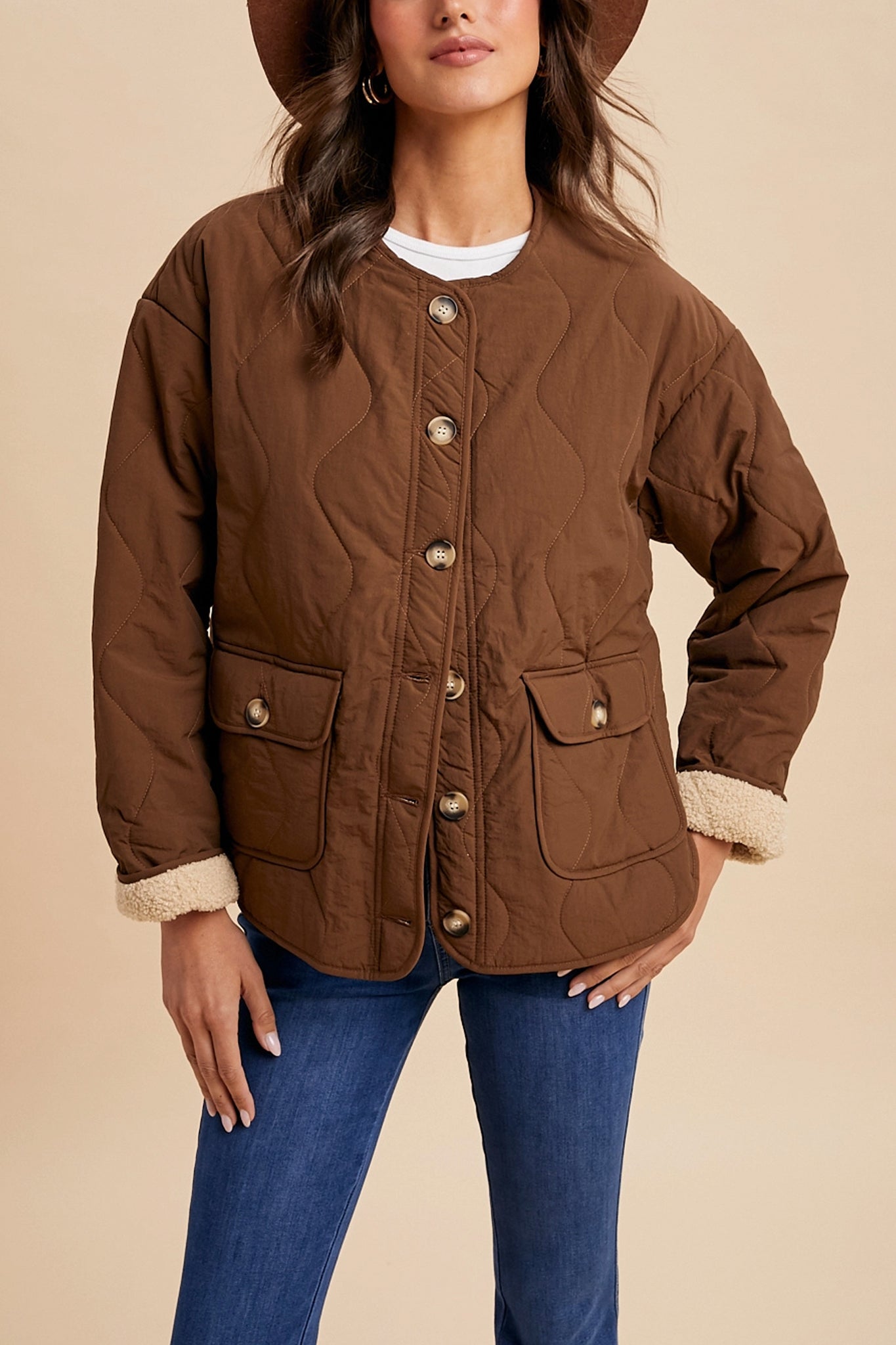 Embrace boho coastal vibes with Larrea Cove's Highland sherpa-lined quilted jacket in warm chestnut, perfect for outerwear journeys.