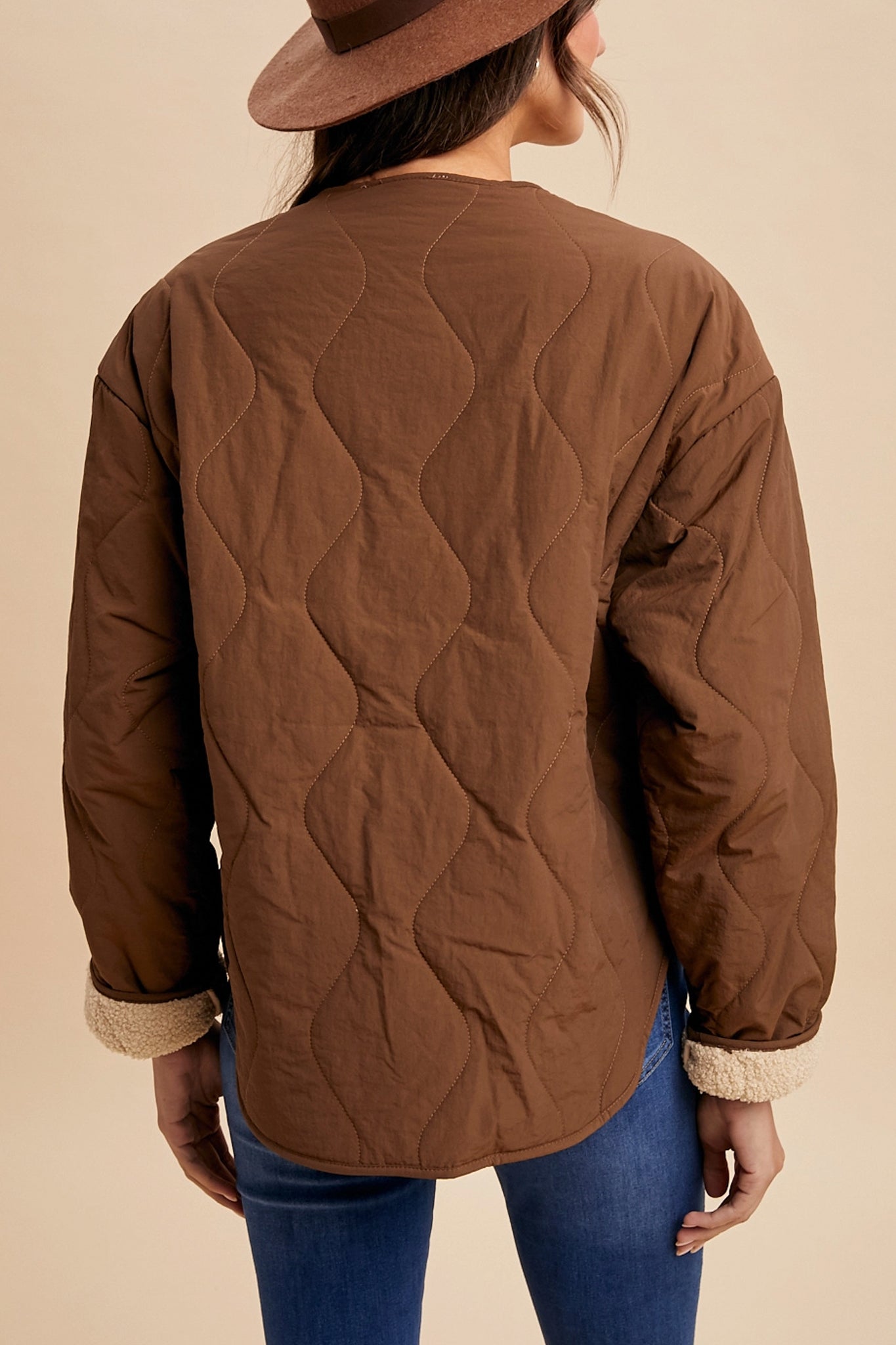 Highland Sherpa-lined quilted jacket in chestnut offers cozy warmth, perfect for boho coastal adventures from Larrea Cove.