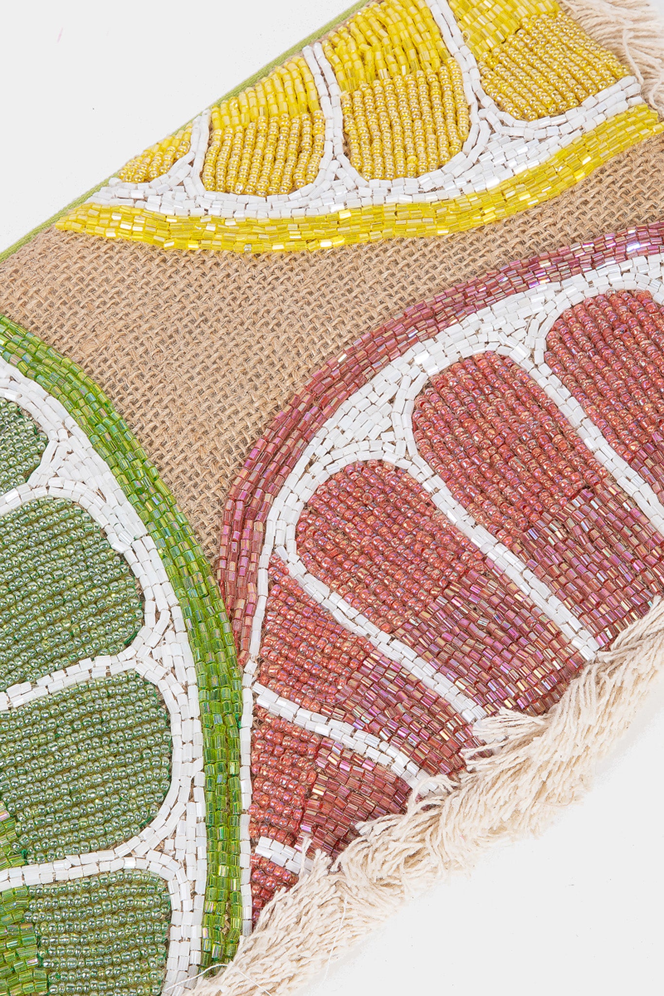 A stylish Summer Citrus Jute Clutch by ANTIK KRAFT, featuring a vibrant citrus pattern. The clutch is made from jute material, showcasing a natural, textured look. It is displayed alongside a pair of sunglasses, suggesting a summer-ready accessory. Ideal for casual outings or beach trips, this clutch embodies a fresh and trendy aesthetic for the Summer 2024 season.