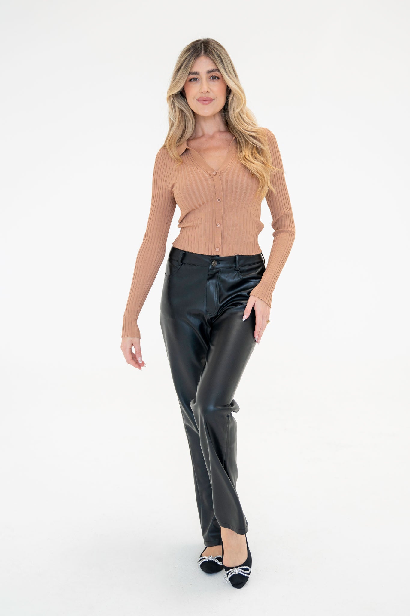 Raywood Straight Leg Vegan Leather Pants by Larrea Cove, featuring a sleek, modern design with straight legs, displayed alongside stylish sunglasses. Ideal for fall fashion.