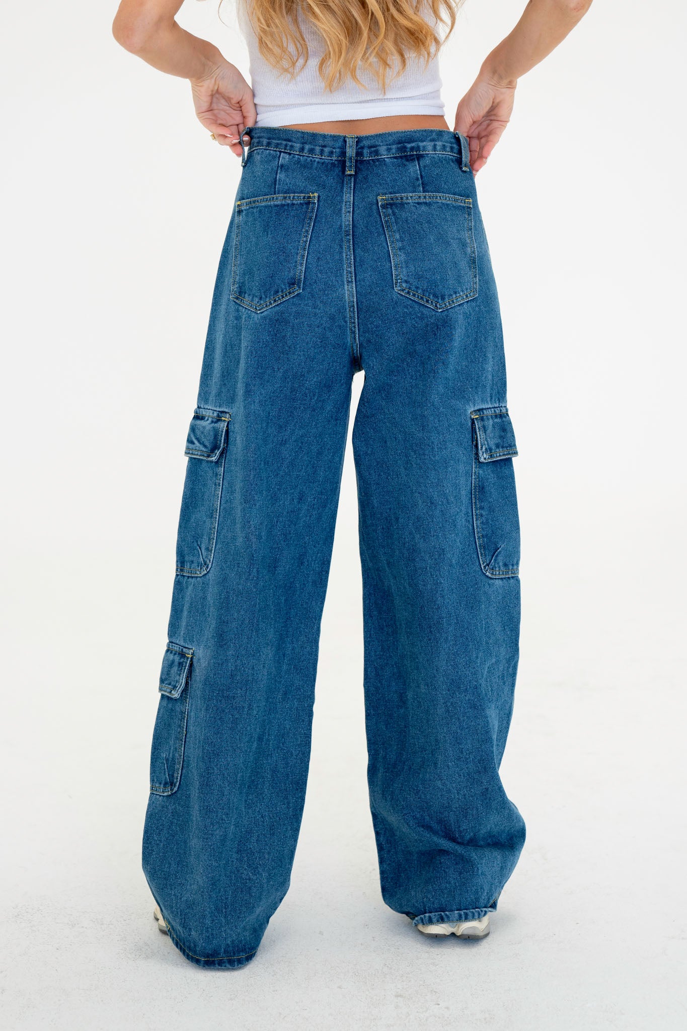 Wide leg cargo denim pants in a light blue wash, featuring multiple pockets and a relaxed fit. Paired with stylish sunglasses, the outfit embodies a trendy fall look. Ideal for casual wear, these jeans are part of a last-chance sale from Blu Pepper for September 2023.