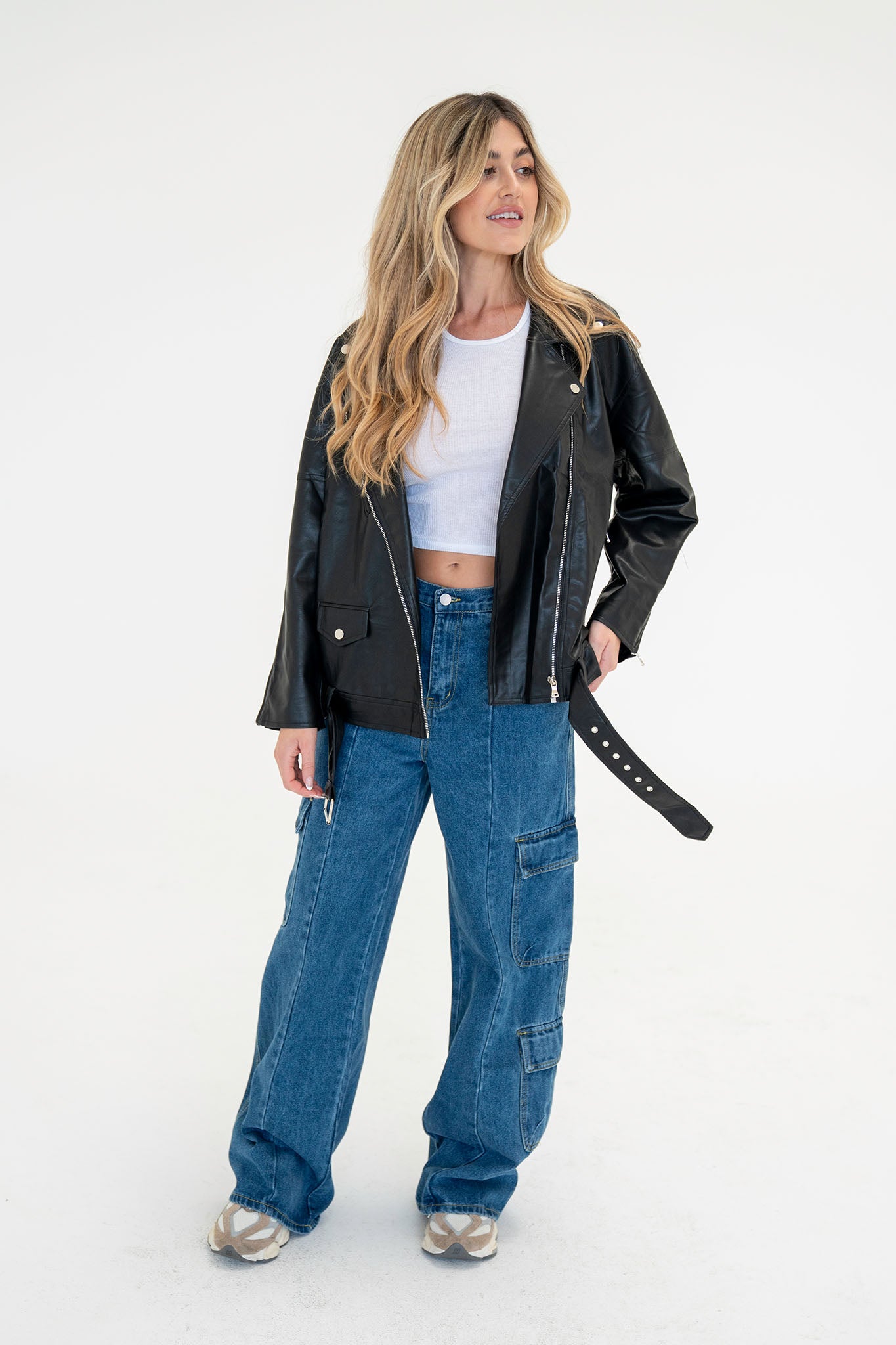 Wide leg cargo denim pants in a light blue wash, featuring large side pockets and a relaxed fit. The pants are styled with a pair of sunglasses resting on top, suggesting a casual, trendy look.