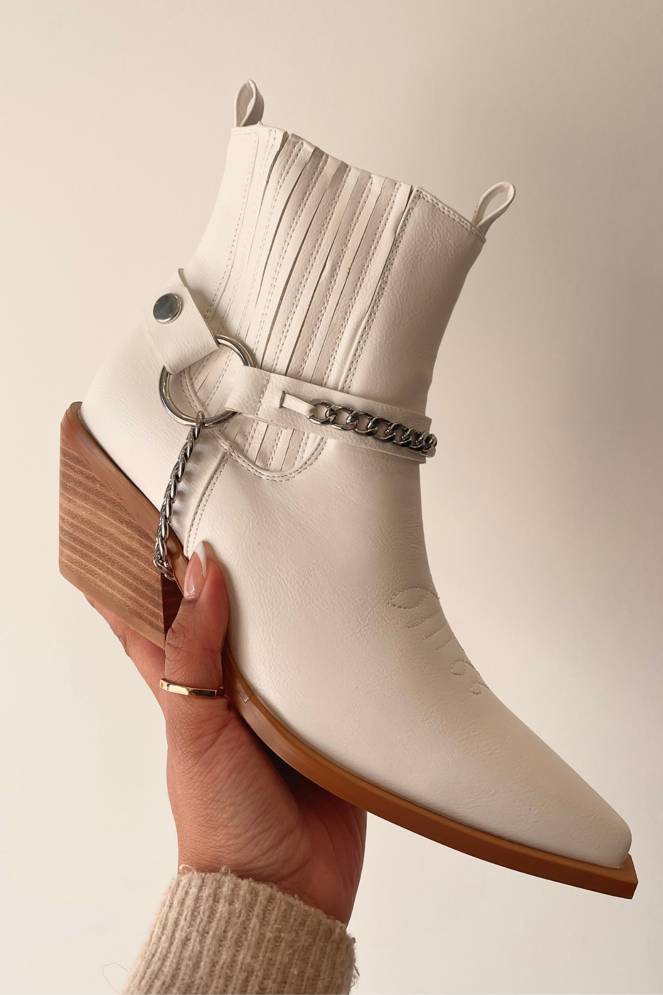 A stylish Billini Ellison Bootie featuring a sleek monochrome design. The bootie is elegant and modern, perfect for pairing with various outfits. Accompanying the bootie are fashionable sunglasses, adding a chic accessory element. This product is part of a 2023 sale and falls under the category of shoes in apparel and accessories.