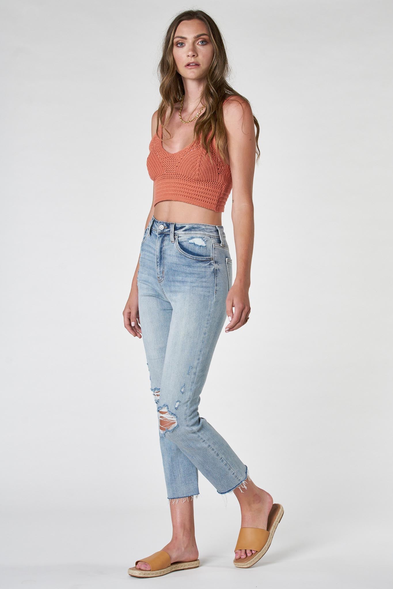 A pair of Eunina Ally Straight Jeans in a Saguaro color, featuring a classic straight-leg cut. The jeans are displayed against a neutral background, highlighting their design and fabric texture. Accompanying the jeans are stylish sunglasses, adding a trendy accessory element to the outfit.
