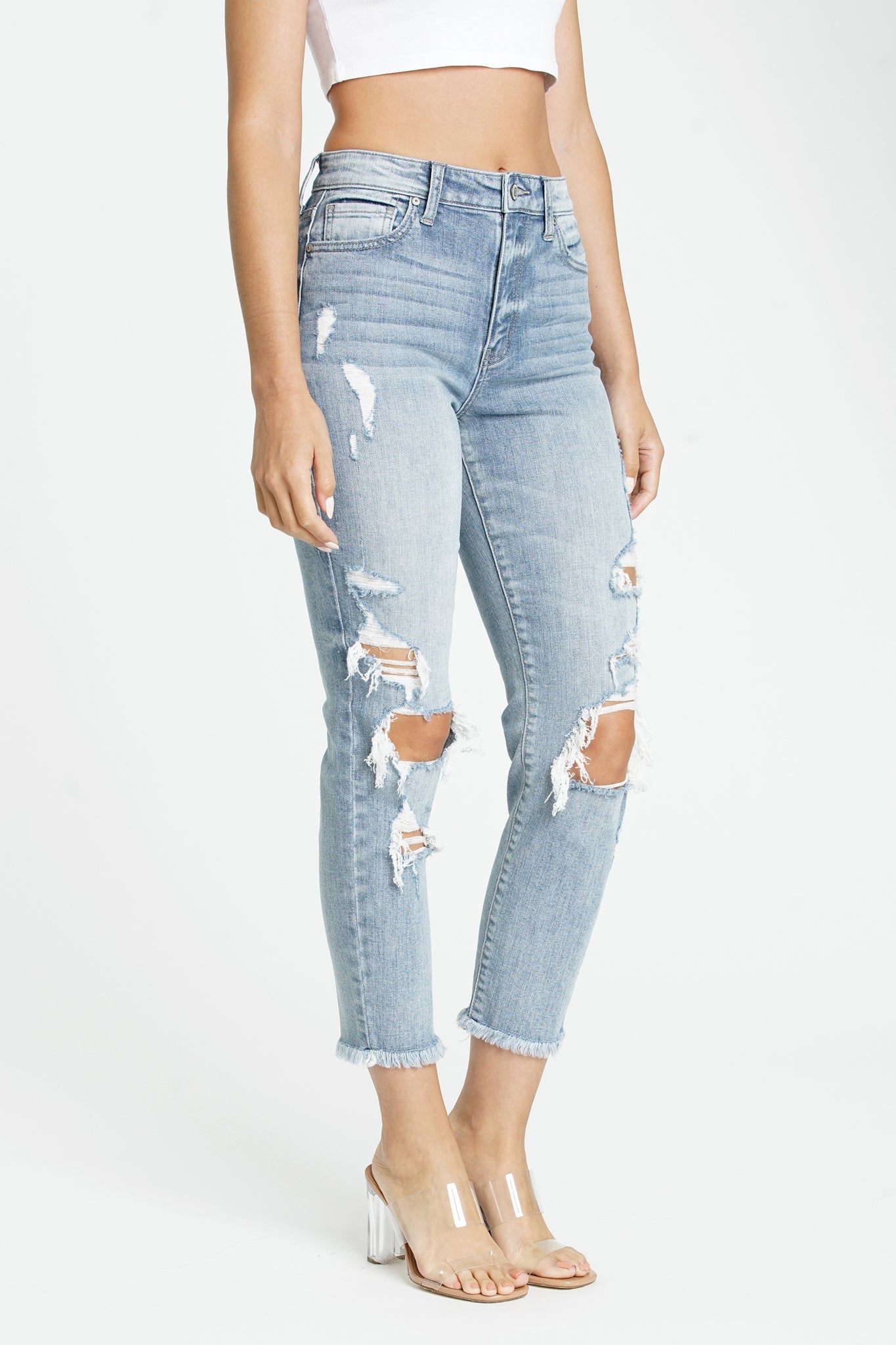 A pair of Eunina Tobi Mom Jeans in Cardon color, featuring a relaxed fit and high waist. The jeans are styled casually, showcasing their versatile design suitable for various outfits. Accompanying the jeans are a pair of stylish sunglasses, enhancing the overall look. The product is part of a new collection available for pre-order with restock options.