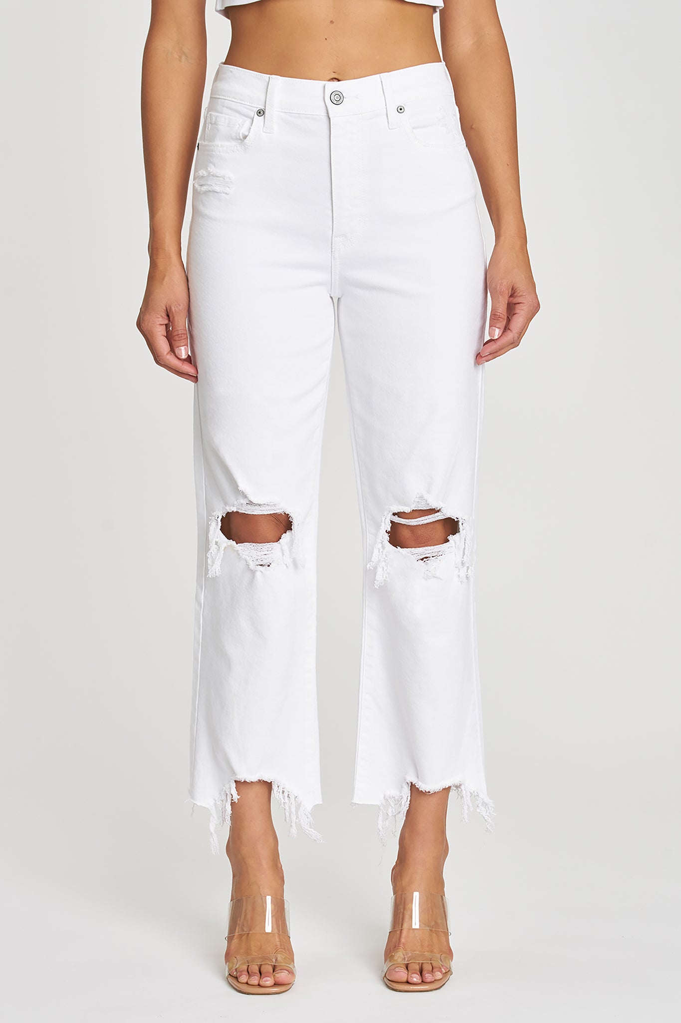 A pair of Eunina Dawn Wide Leg Jeans in Datura, featuring a light blue denim fabric with a relaxed wide leg silhouette. The jeans are styled with a casual look, perfect for spring. Accompanying the jeans are a pair of trendy sunglasses, adding a chic accessory to the outfit. The image may include tags related to sales and seasonal promotions for spring 2023, indicating it's a new product.