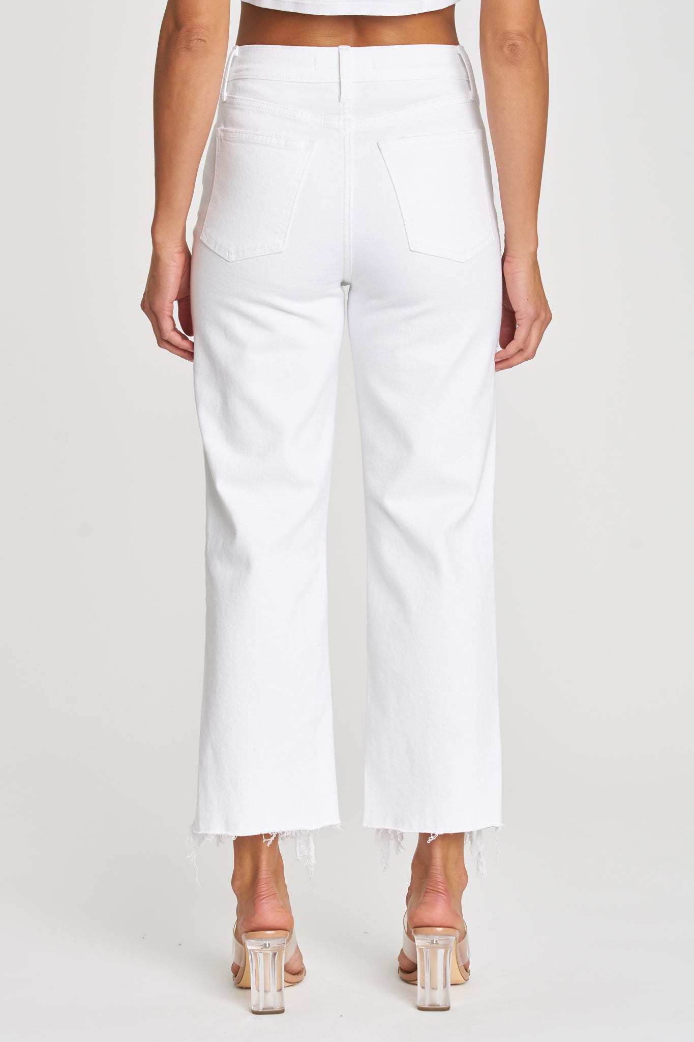 A pair of Eunina Dawn Wide Leg Jeans in Datura, featuring a light blue denim color with a relaxed wide-leg fit. The jeans are styled with a casual look, suitable for spring. The image may also include sunglasses as an accessory.