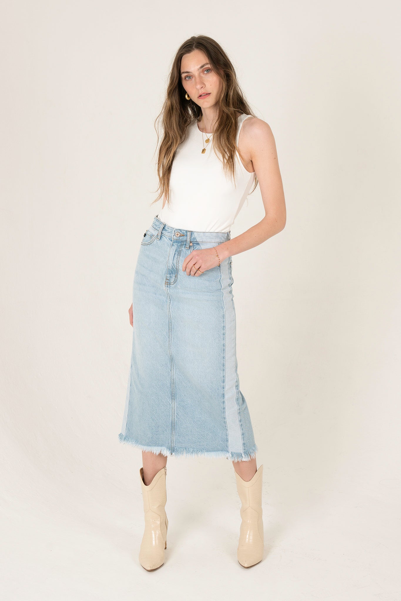 View 1 of KanCan Midi Denim Skirt, a Skirts from Larrea Cove. Detail: The KanCan Midi Denim Skirt is sure to turn heads th...