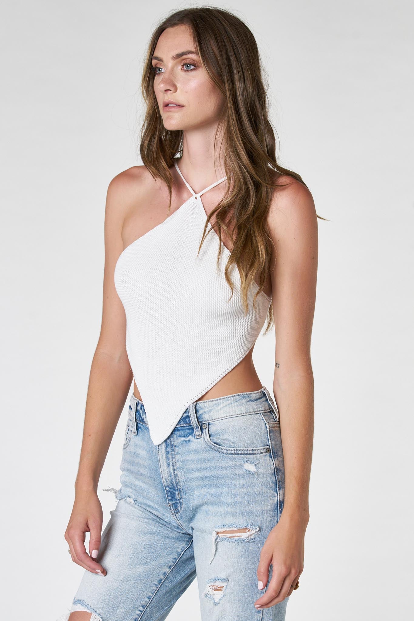 The image features a stylish top from the Desertlily collection by Larrea Cove, showcasing a modern design suitable for casual wear. The top likely has a unique pattern or color, reflecting a trendy aesthetic. Accompanying the top are fashionable sunglasses, enhancing the overall look. The product is tagged with various sale indicators, suggesting a promotional offer. This item falls under the category of clothing tops in the apparel and accessories section.